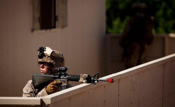Pfc. Christopher Bewell, a mortarman with India Company, 3rd Battalion, 3rd Marine Regiment, holds security from a rooftop during counterinsurgency training on Marine Corps Base Hawaii, Aug. 15, 2011. The infantry Marines are preparing for the Mojave Viper exercise at Marine Corps Air Ground Combat Center Twentynine Palms, Calif., at the end of August, following pre-deployment training on the Island of Hawaii and here. This month long training event will be 3/3’s final evaluation before deploying to Afghanistan’s Helmand province in support of Operation Enduring Freedom this fall. Bewell, 19, is from Lowell, Mich.
