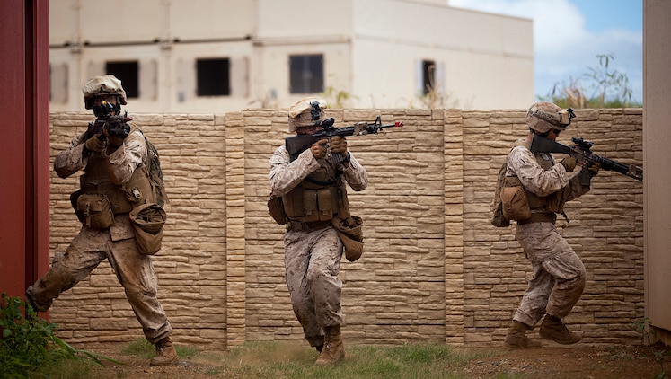 Marines with India Company, 3rd Battalion, 3rd Marine Regiment, move down a corridor while clearing houses during counterinsurgency training on Marine Corps Base Hawaii, Aug. 15, 2011. The infantry Marines are preparing for the Mojave Viper exercise at Marine Corps Air Ground Combat Center Twentynine Palms, Calif., at the end of August, following pre-deployment training on the Island of Hawaii and here. This month long training event will be 3/3’s final evaluation before deploying to Afghanistan’s Helmand province in support of Operation Enduring Freedom this fall.
