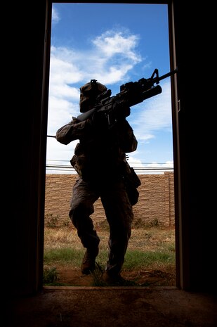Lance Cpl. James Horton, a team leader with India Company, 3rd Battalion, 3rd Marine Regiment, moves to clear a house during counterinsurgency training on Marine Corps Base Hawaii, Aug. 15, 2011. The infantry Marines are preparing for the Mojave Viper exercise at Marine Corps Air Ground Combat Center Twentynine Palms, Calif., at the end of August, following pre-deployment training on the Island of Hawaii and here. This month long training event will be 3/3’s final evaluation before deploying to Afghanistan’s Helmand province in support of Operation Enduring Freedom this fall. Horton, 21, is from Lynchburg, Tenn.