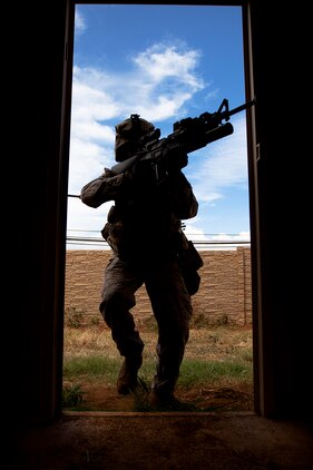 Lance Cpl. James Horton, a team leader with India Company, 3rd Battalion, 3rd Marine Regiment, moves to clear a house during counterinsurgency training on Marine Corps Base Hawaii, Aug. 15, 2011. The infantry Marines are preparing for the Mojave Viper exercise at Marine Corps Air Ground Combat Center Twentynine Palms, Calif., at the end of August, following pre-deployment training on the Island of Hawaii and here. This month long training event will be 3/3’s final evaluation before deploying to Afghanistan’s Helmand province in support of Operation Enduring Freedom this fall. Horton, 21, is from Lynchburg, Tenn.