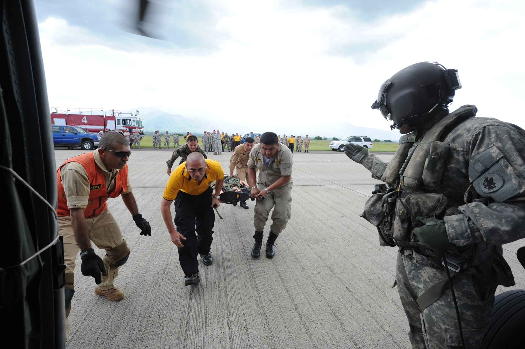 Honduran and Costa Rican firefighters bring a litter to a waiting UH-60 helicopter during an exercise at Soto Cano Air Base, Honduras, Aug. 16, 2011. The exercise, called Central America Sharing Mutual Operational Knowledge and Experiences or CENTAM SMOKE, allows U.S., Honduran and Costa Rican firefighters four days of team-building training. (U.S. Air Force photo/Tech. Sgt. Matthew McGovern)  
