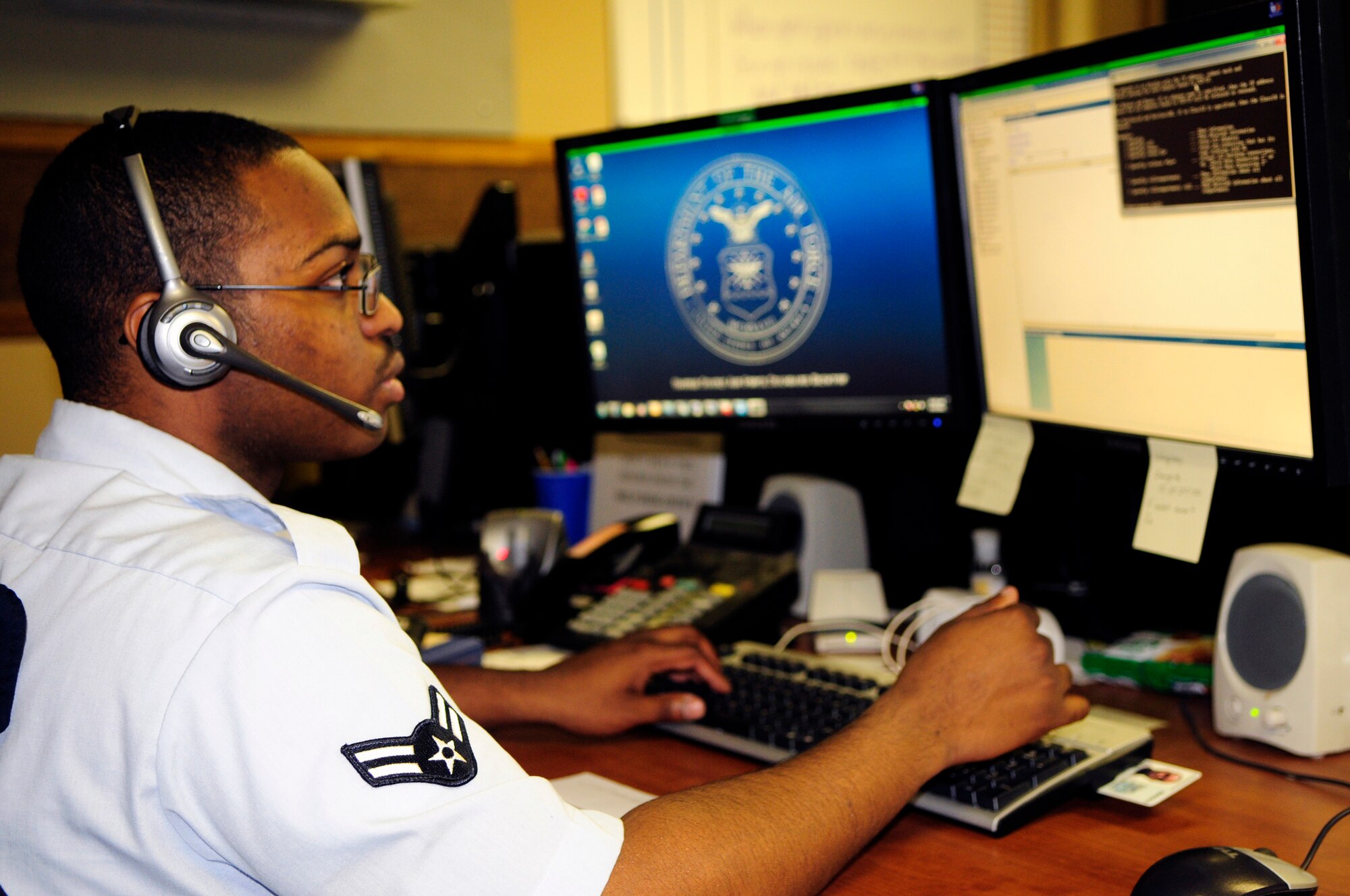 Airman 1st Class Marcus Hall uses online resources to provide customer support via telephone August 15, 2011, Eielson Air Force Base, Alaska.  The Eielson Network Control Center is responsible for more than 2,200 computers on the base and ensures that all network patches are up to date on each Airman's computer on Eielson. Airman Hall is assigned to the 354th Communications Squadron as a cyber systems operations technician.  (U.S. Air Force photo by/Airman 1st Class Yash Rojas)