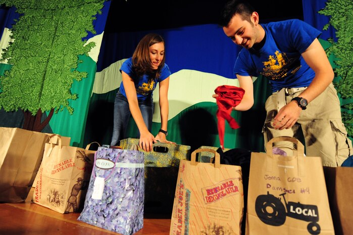 Morgan Briggs and Ross Egan, Missoula Children's Theatre tour actor/directors, prepare the stage for a youth performance of "King Arthur's Quest" Aug. 12, 2011, at the base theater at Nellis Air Force Base, Nev.  The MCT International Tour conducts residency weeks on the vast majority of military bases around the world.  During this time, military children ages five to 18 have the opportunity to perform a play directed by MCT staff.  (U.S. Air Force photo by Staff Sgt. William P.Coleman/Released)