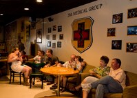 Attendees at the re-opening of the Dakota’s Club Enlisted Lounge sit and enjoy the music of a live band at Ellsworth Air Force Base, S.D., Aug. 5, 2011. As well as the live band, there were games, discounts on drinks, and gift card drawings, all to celebrate the New Bar, New Beginnings theme. (U.S. Air Force photo/Airman Alystria Maurer/Released)