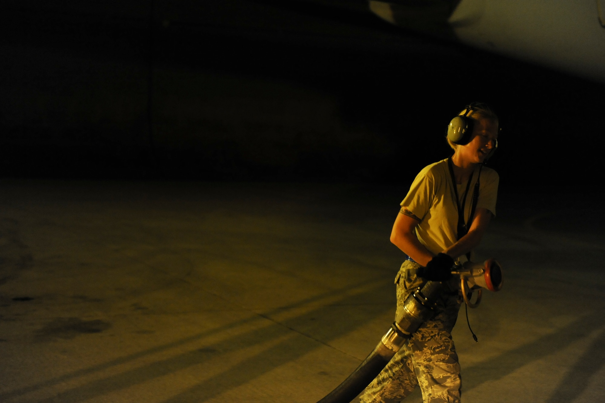 Staff Sgt. Sarah Thomas, 961st Aircraft Maintenance Unit hydraulics craftsman, maneuvers a fuel hose to an E-3 Sentry, an airborne warning and control system aircraft, during a refuel Aug. 16 at Kadena Air Base, Japan. Refueling of aircraft is not a novelty to the 961st AMU Airmen. “This is nothing spectacular to us, it comes as part of the job,” said Thomas. (U.S. Air Force photo/ Airman 1st Class Brooke P. Beers)