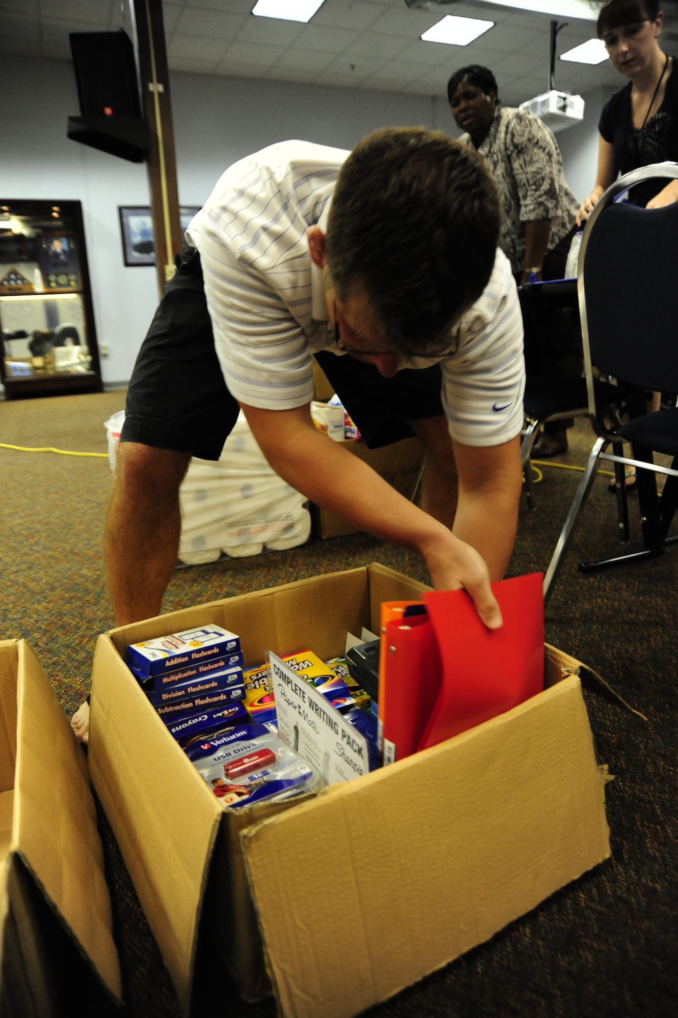 Tech. Sgt. Jay Field, 605th Test and Evaluation Squadron project manager, packs a box of school supplies at the 505th Command and Control Wing headquarters at Hurlburt Field, Fla., August, 16, 2011.  505th CCW Airmen donated items such as backpacks, markers, glue sticks and notebooks for children of the local community. (U.S. Air Force photo by Airman Naomi M. Griego)

