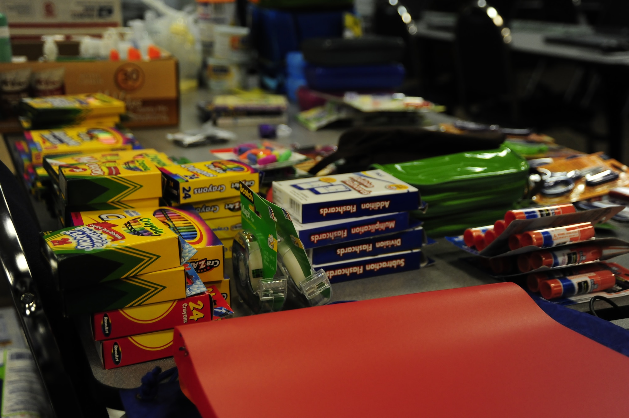 School supplies are neatly stacked on a table at the 505th Command and Control wing headquarters at Hurlburt Field, Fla., August 16, 2011.  505th CCW Airmen donated school supplies to create back-to-school kits for children of the local community. (U.S. Air Force photo by Airman Naomi M. Griego)
