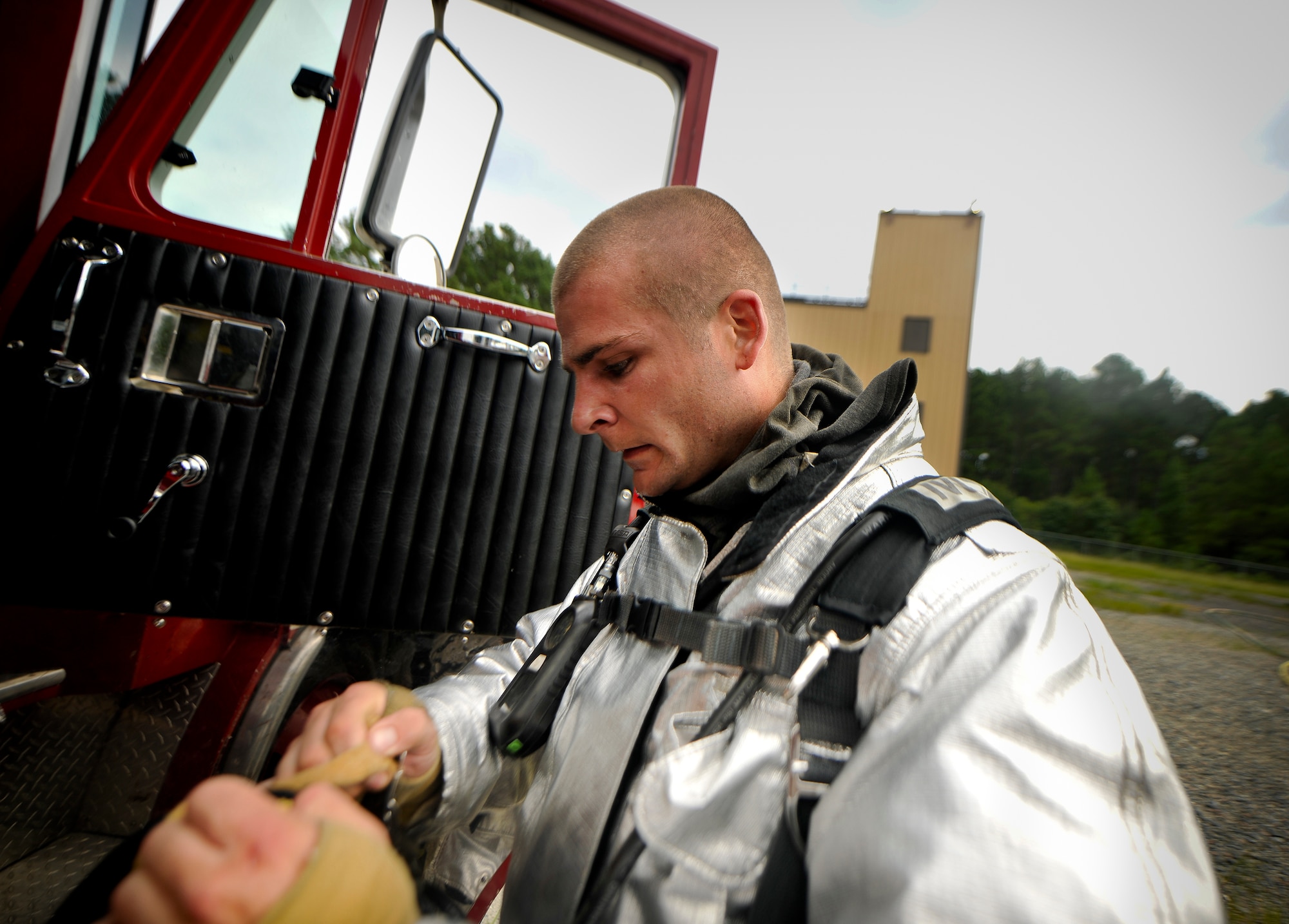 U.S. Air Force Staff Sgt. Eric Barlow, 23rd Civil Engineer Squadron firefighter crew chief, removes his gear at the end of scenario during a phase II operational readiness exercise (ORE) at Moody Air Force Base, Ga., Aug. 16, 2011. Barlow and other Airmen from the 23rd CES participating in the exercise will be tasked with multiple scenario injects to test their ability to accomplish the job in a deployed environment. (U.S. Air Force photo by Airman 1st Class Joshua Green/Released)
