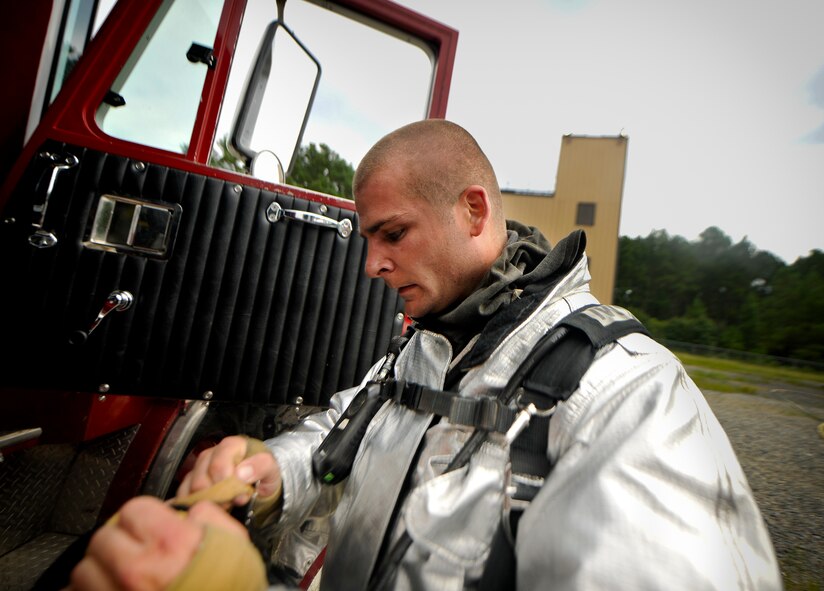 U.S. Air Force Staff Sgt. Eric Barlow, 23rd Civil Engineer Squadron firefighter crew chief, removes his gear at the end of scenario during a phase II operational readiness exercise (ORE) at Moody Air Force Base, Ga., Aug. 16, 2011. Barlow and other Airmen from the 23rd CES participating in the exercise will be tasked with multiple scenario injects to test their ability to accomplish the job in a deployed environment. (U.S. Air Force photo by Airman 1st Class Joshua Green/Released)
