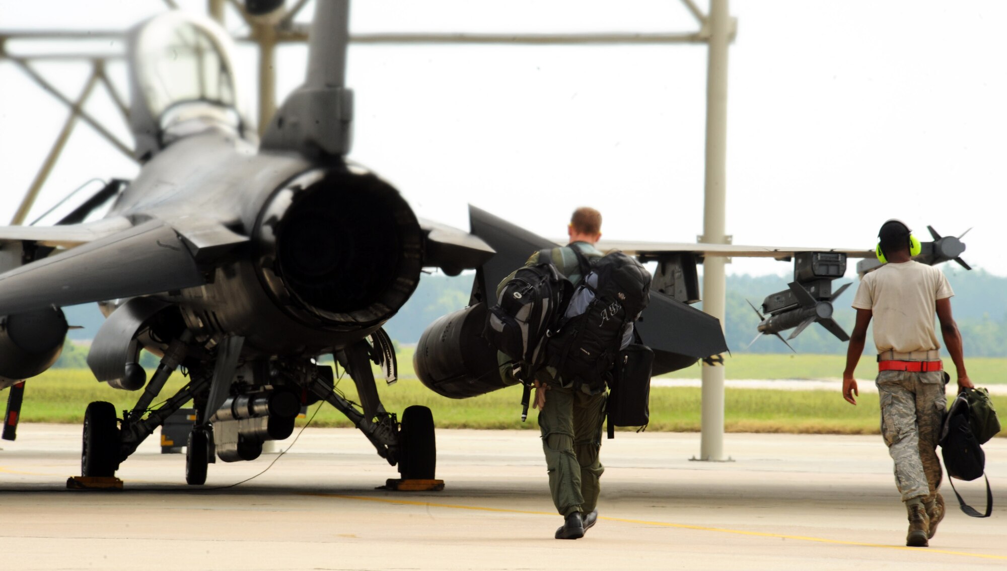 A pilot from the 55th Fighter Squadron and a crew chief from the 20th Aircraft Maintenance Squadron walk toward an F-16 Fighting Falcon in preparation for Green Flag West, Shaw Air Force Base, S.C., Aug. 12, 2011. Green Flag West is an exercise that is held at Nellis AFB, Nev., and takes place ten times a year to prepare aircraft and crews for ground support combat training. (U.S. Air Force photo/Airman 1st Class Tabatha L. Duarte)(Released)