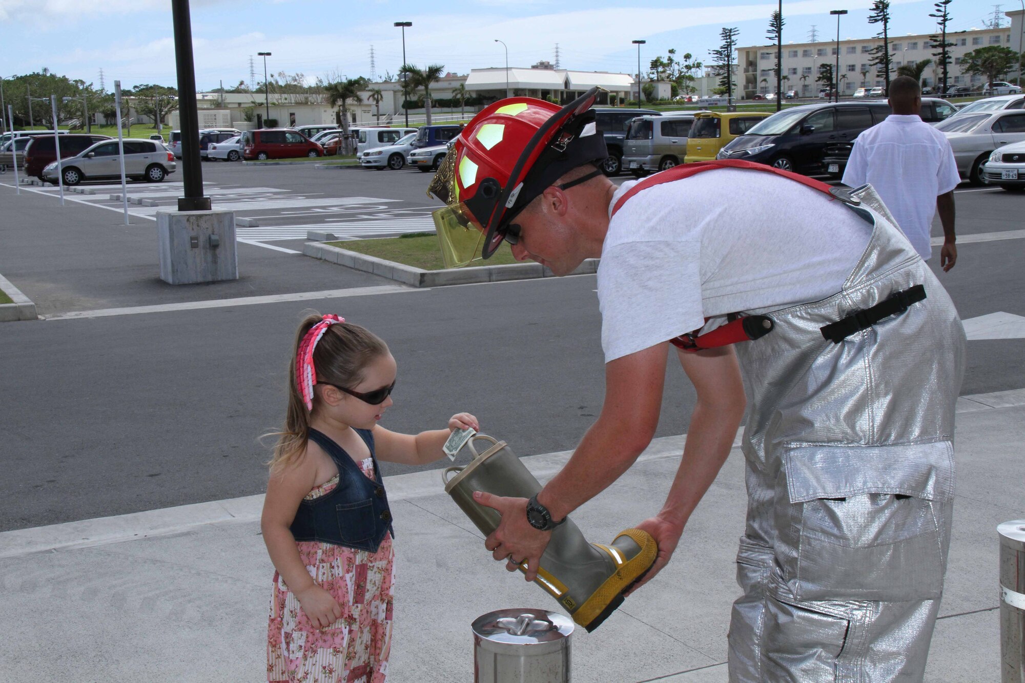 Members of the Kadena fire and emergency services held a “Fill the Boot” Kadena Special Olympics fundraiser to collect money outside of the base exchange at Kadena Air Base, Japan, Aug. 13. The organization raised over $23,000, more than they have ever risen in this annual charity event. (U.S. Army photo/Charles Steitz)