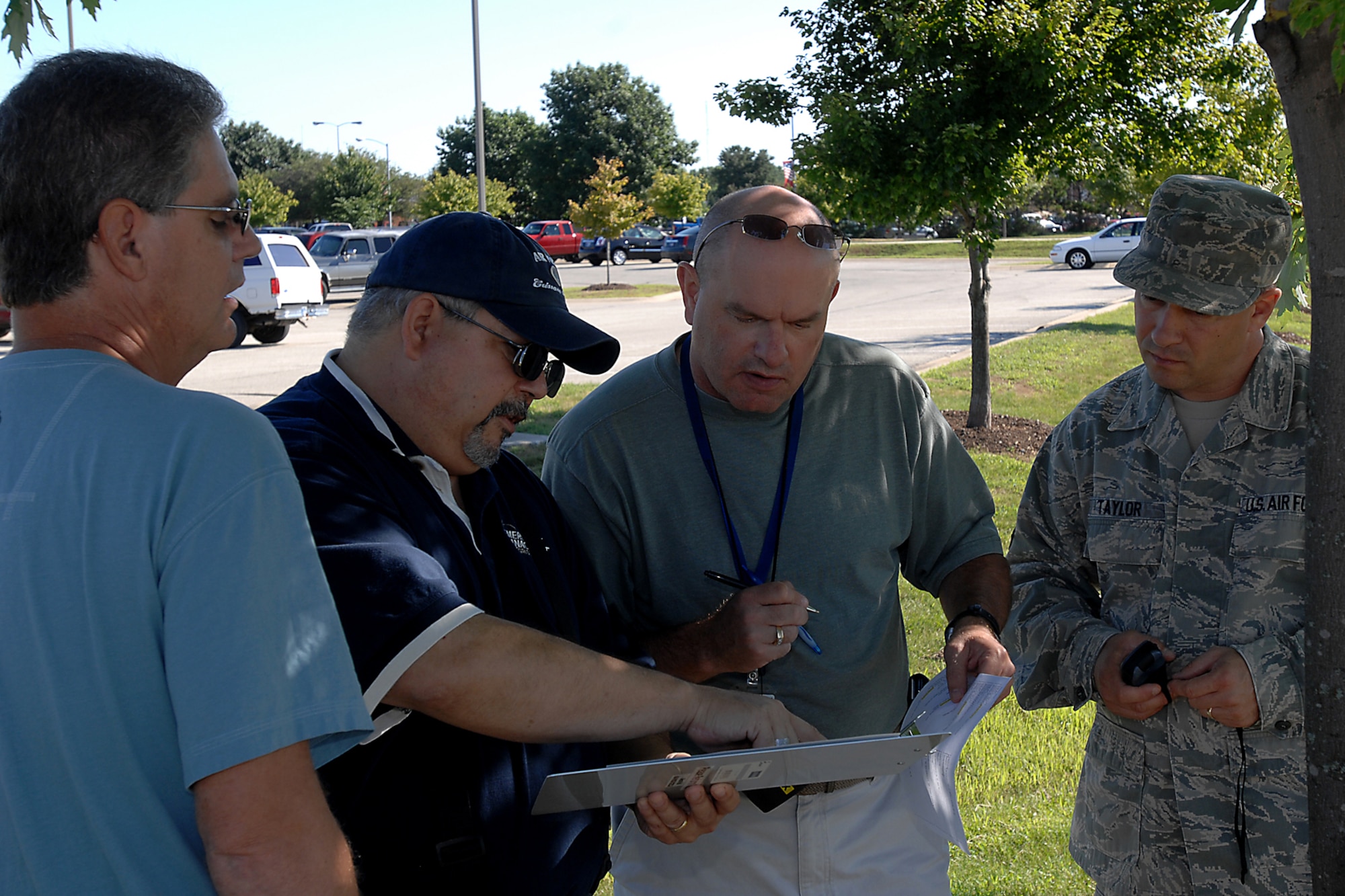 GRISSOM AIR RESERVE BASE, Ind. -- Bob L. Wydock, Jr., 434th Civil Engineer Squadron emergency management program assistant, teaches team members how to read and plot exact coordinates on a map during an exercise Aug. 11. The hands-on exercise equipped emergency management readiness support team members with some fundamental skills necessary to accomplish their emergency response mission here. From left is Steve Krawczyk, 434th CES civil engineer technician; Wydock; Kevin Yeager, 434th Communication Squadron communication focal point technician; and Master Sgt. Shane Taylor, 434th Operations Support Squadron aircrew flight equipment technician. (U.S. Air Force photo/Senior Airman Jami K. Lancette)
