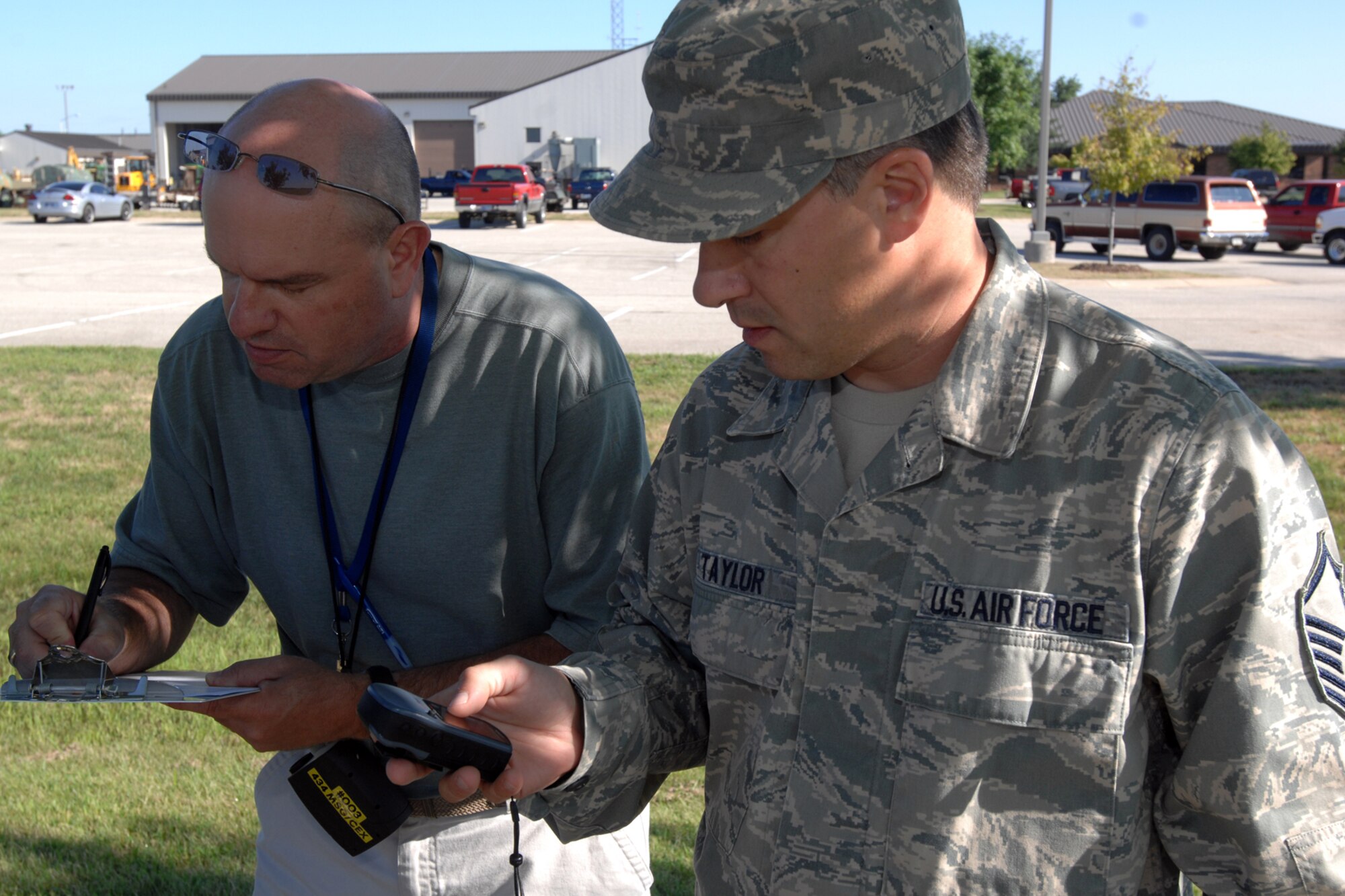 GRISSOM AIR RESERVE BASE, Ind. -- Master Sgt. Shane Taylor, 434th Operations Support Squadron aircrew flight equipment technician, and Kevin Yeager, 434th Communication Squadron communication focal point technician, plot their exact location during an exercise aimed at sharpening skills they've acquired as emergency management readiness support team members at Grissom Aug. 11. (U.S. Air Force photo/Senior Airman Jami K. Lancette)