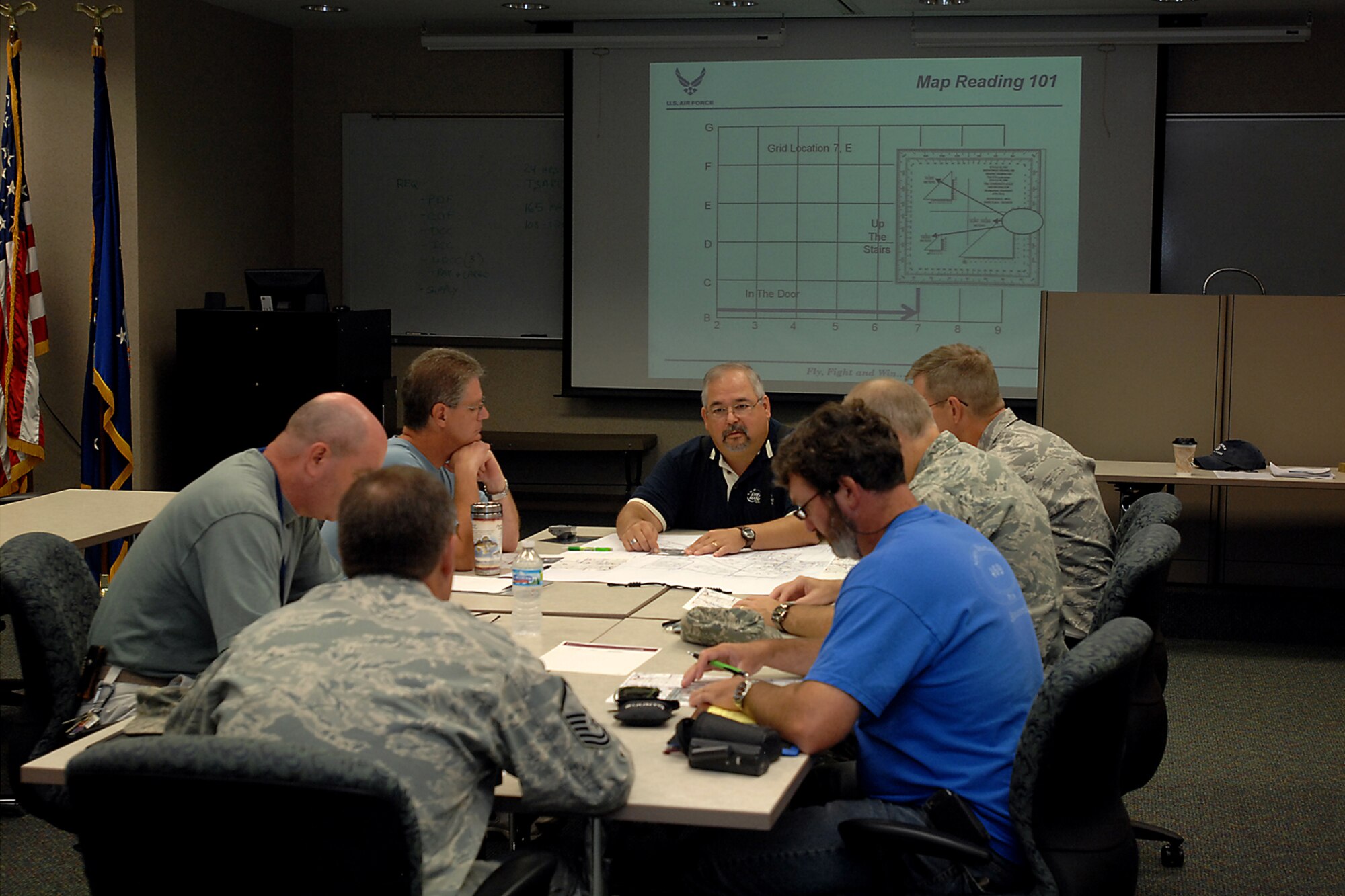 GRISSOM AIR RESERVE BASE, Ind. -- Bob L. Wydock, Jr., 434th Civil Engineer Squadron emergency management program assistant, helps set emergency management readiness support team members up for success in preparing them to be able to properly read maps, grid coordinates, GPS, ranger finders and compasses here Aug. 11. The knowledge and training that they acquire will better prepare them if an emergency were to transpire. (U.S. Air Force photo/Senior Airman Jami K. Lancette)