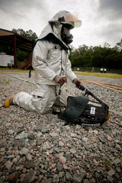 U.S. Air Force Senior Airman Latavis Johnson, 23rd Civil Engineer Squadron firefighter, removes his gear after fighting a simulated fire during a Phase II operational readiness exercise (ORE) at Moody Air Force Base, Ga., Aug. 16, 2011. The ORE allowed Johnson and fellow firefighters to train on fighting real world fires. (U.S. Air Force Photo by Staff Sgt. Joshua J. Garcia/Released)