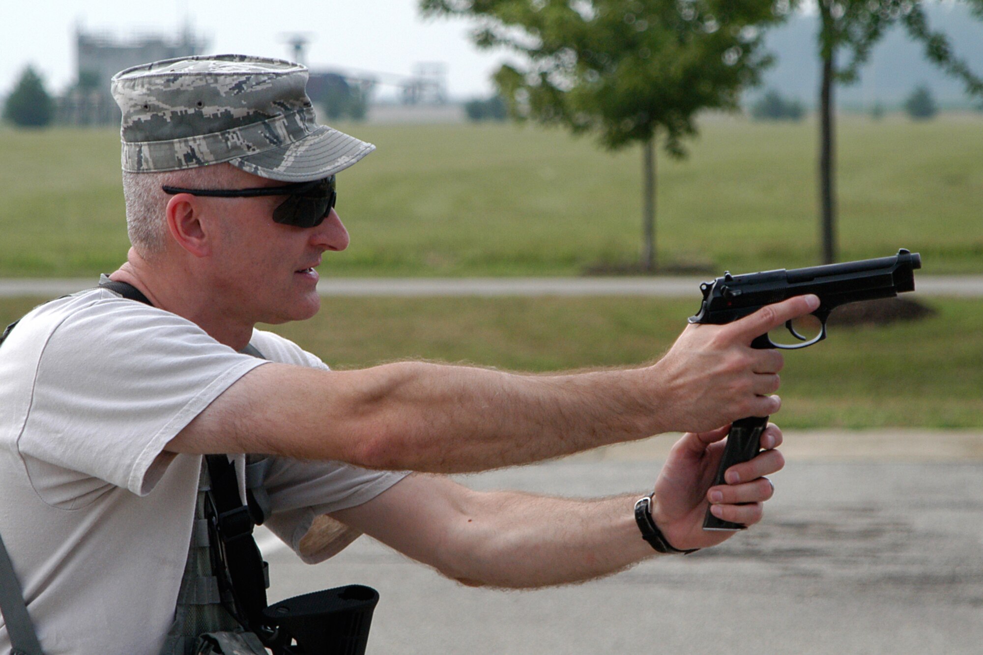 GRISSOM AIR RESERVE BASE, Ind. -- Senior Master Sgt. Rickie King, 434th Security Forces Squadron operations superintendent, demonstrates the proper reloading technique of an M-9 pistol while conducting weapons training during the August unit training assembly here. Security Forces members practiced reloading and quick change weapons drills to keep their skills sharp. (U.S. Air Force photo/Senior Airman Andrew McLaughlin)                                