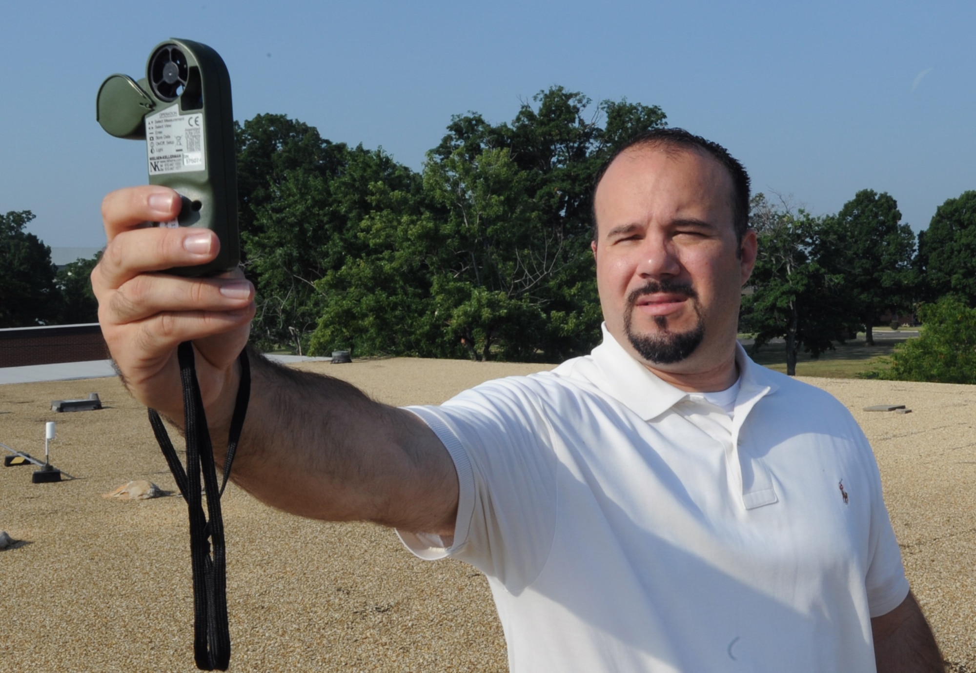 Sean Lewin, 89th Operations Support Squadron meteorological technician, determines the speed and direction of the prevailing wind at Joint Base Andrews July 29.  The weather flight provides information for mission planning and execution, base activities and asset protection.  (U.S. Air Force photo by Senior Airman Torey Griffith)