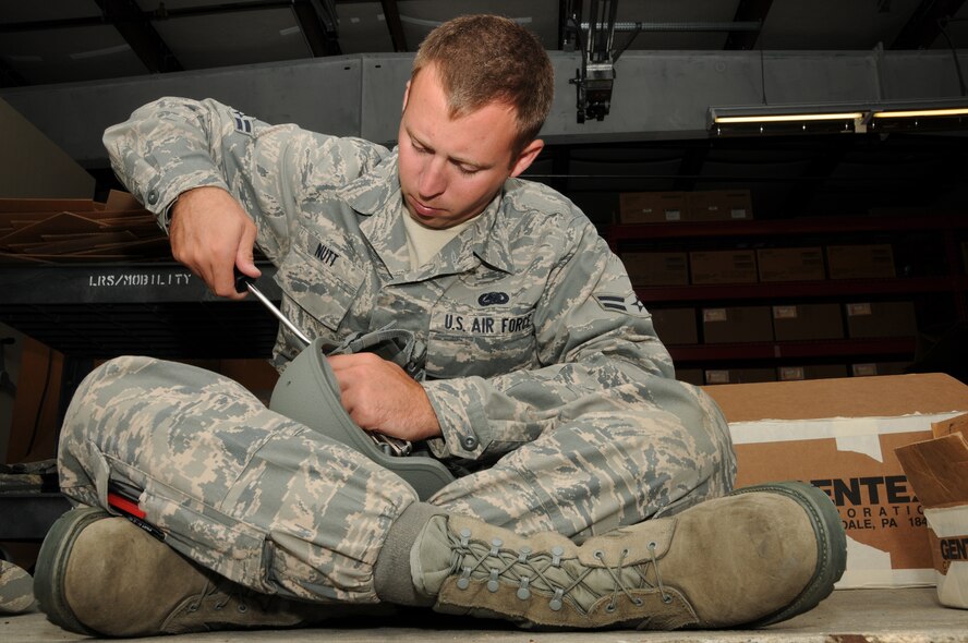 Airman First Class KelseyJ. Nutt repairs an Advanced Combat Helmet, Pease Air National Guard Base, New Hampshire August 16th, 2011.  Airman Nutt is a supply specialist assigned to the 260th Air Traffic Control Squadron here at Pease.  (U.S. Air Force photo/Staff Sgt. Curtis J. Lenz) (RELEASED)