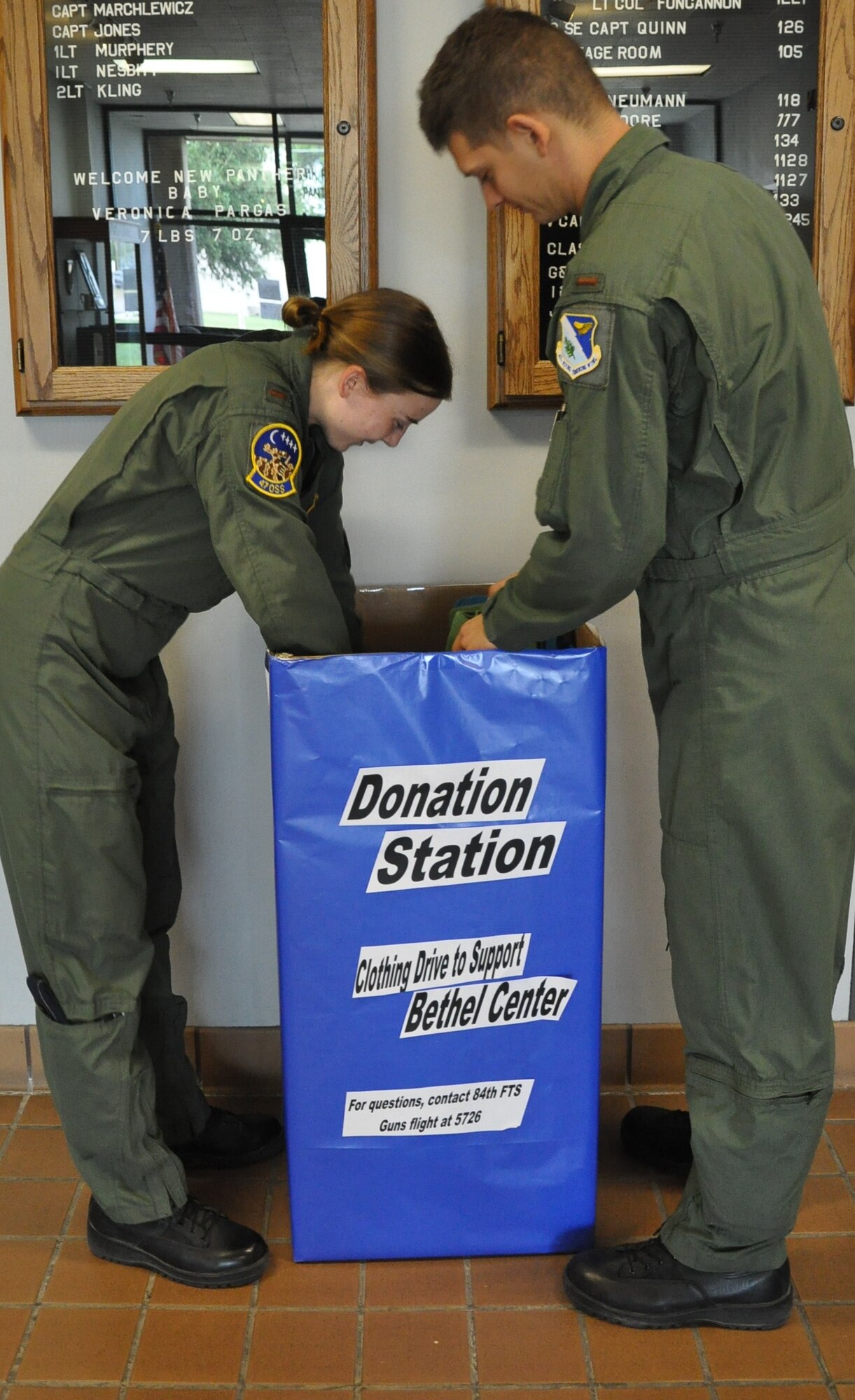 LAUGHLIN AIR FORCE BASE, Texas - - Second Lt. Alicia Durnin and 2nd Lt. Travis Delzer, both of the 47th Operations Support Squadron, make clothing donations to support the Bethel Center  of Val Verde County clothing drive. Clothing collection bins will be located throughout the 84th Flying Training Squadron, 86th FTS and at the Airman and Family Readiness Center until Sept. 9. (U.S. Air Force photo by 2nd Lt. Angela Martin) 