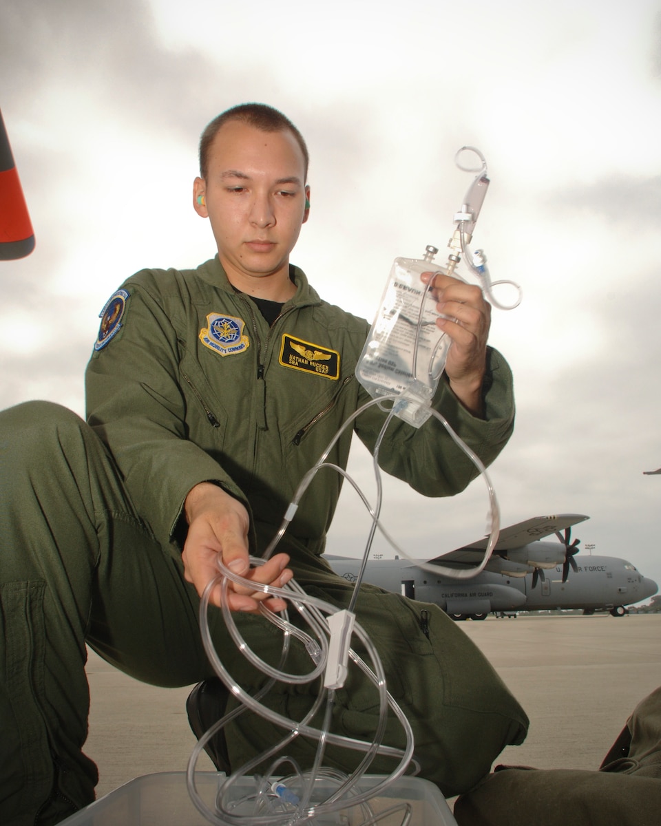 Senior Airman Nathan Rucker prepares to apply a IV (Intravenous machine) to a training mannequin during a training exercise on the flight line with the 146th Aeromedical Evacuation Squadron at the 146th Airlift Wing Port Hueneme, Calif. August 10, 2011. Senior Airman Rucker is the 146th Airlift Wing's Featured Airman of the Month during the month of September 2011.  (U.S. Air Force photo by Airman 1st Class Nicholas Carzis)