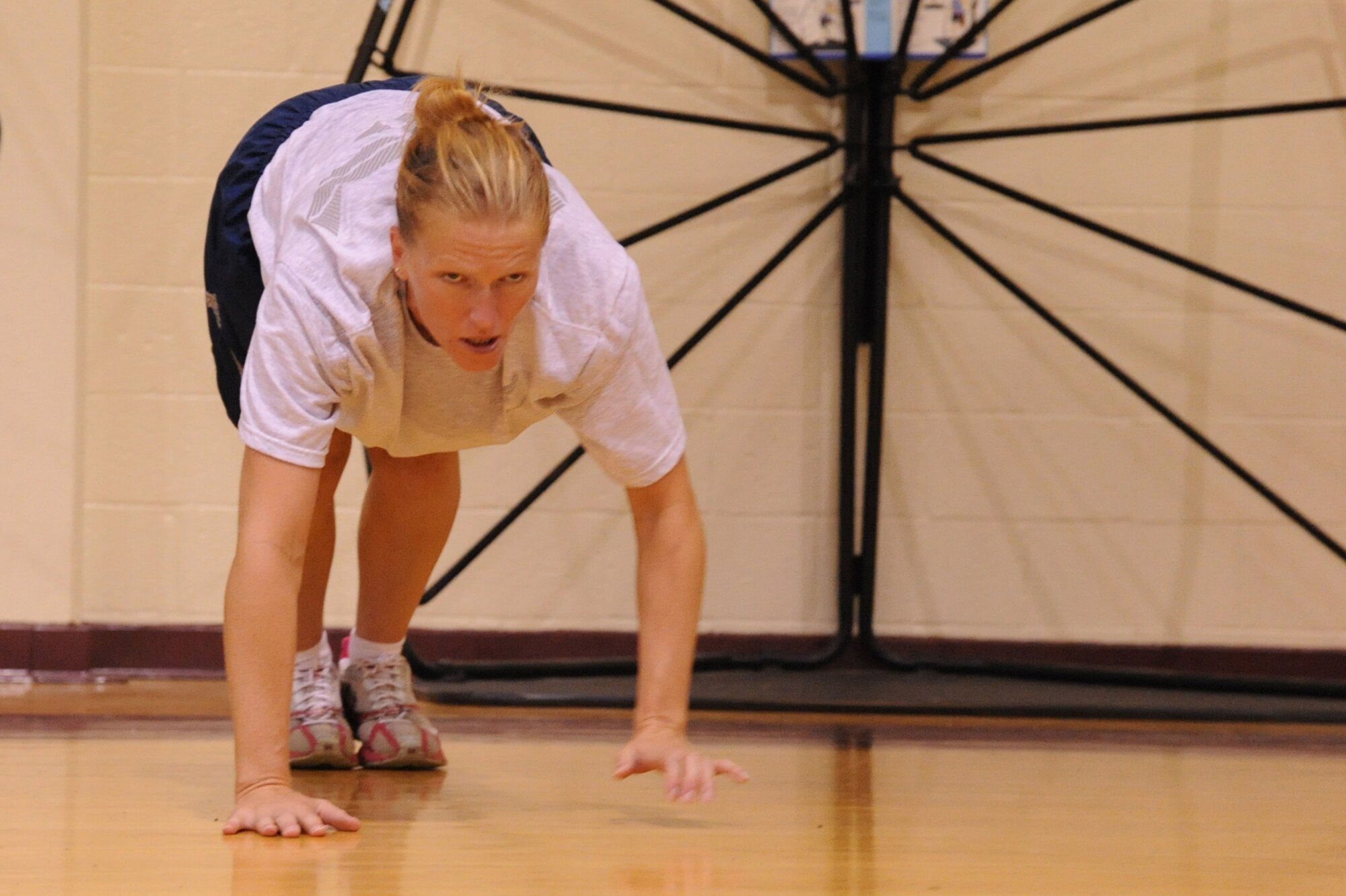 SEYMOUR JOHNSON AIR FORCE BASE, N.C.- Tech. Sgt. Amy Lane crawls forward into a push-up positions during a boot camp session here Aug. 15, 2011. Lane has lost 20 pounds and improved her upper body strength while participating in boot camp for a month. Lane is a native of Sandwich, Ill., (U.S. Air Force photo by Senior Airman Whitney Lambert/Released)