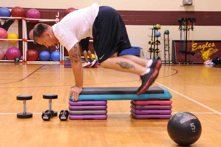 SEYMOUR JOHNSON AIR FORCE BASE, N.C.- Tech. Sgt. Jim Archuleta jumps over a step platform during a boot camp session here Aug. 15, 2011. Boot camp classes are mixed with a variety of 60-second exercises to work the entire body. Archuleta is a native of Hohen Fels, Germany. (U.S. Air Force photo by Senior Airman Whitney Lambert/Released)