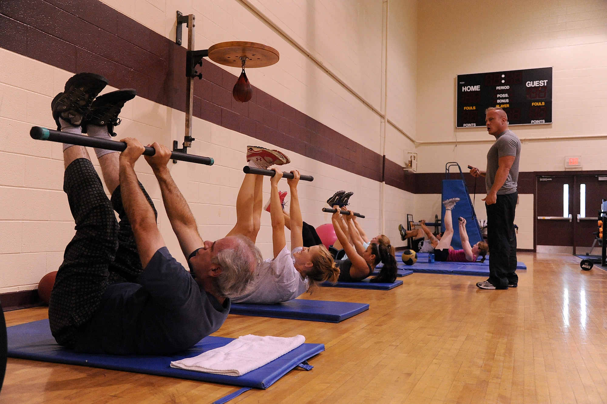 SEYMOUR JOHNSON AIR FORCE BASE, N.C.- Michael Unden, 4th Force Support Squadron military fitness specialist, observes students during a boot camp class here Aug. 15, 2011. Unden informs his students that slow, controlled movements allows for better contractions and quicker results for the abdominal and core muscles. Unden is a native of Wichita, Kan. (U.S. Air Force photo by Senior Airman Whitney Lambert/Released)