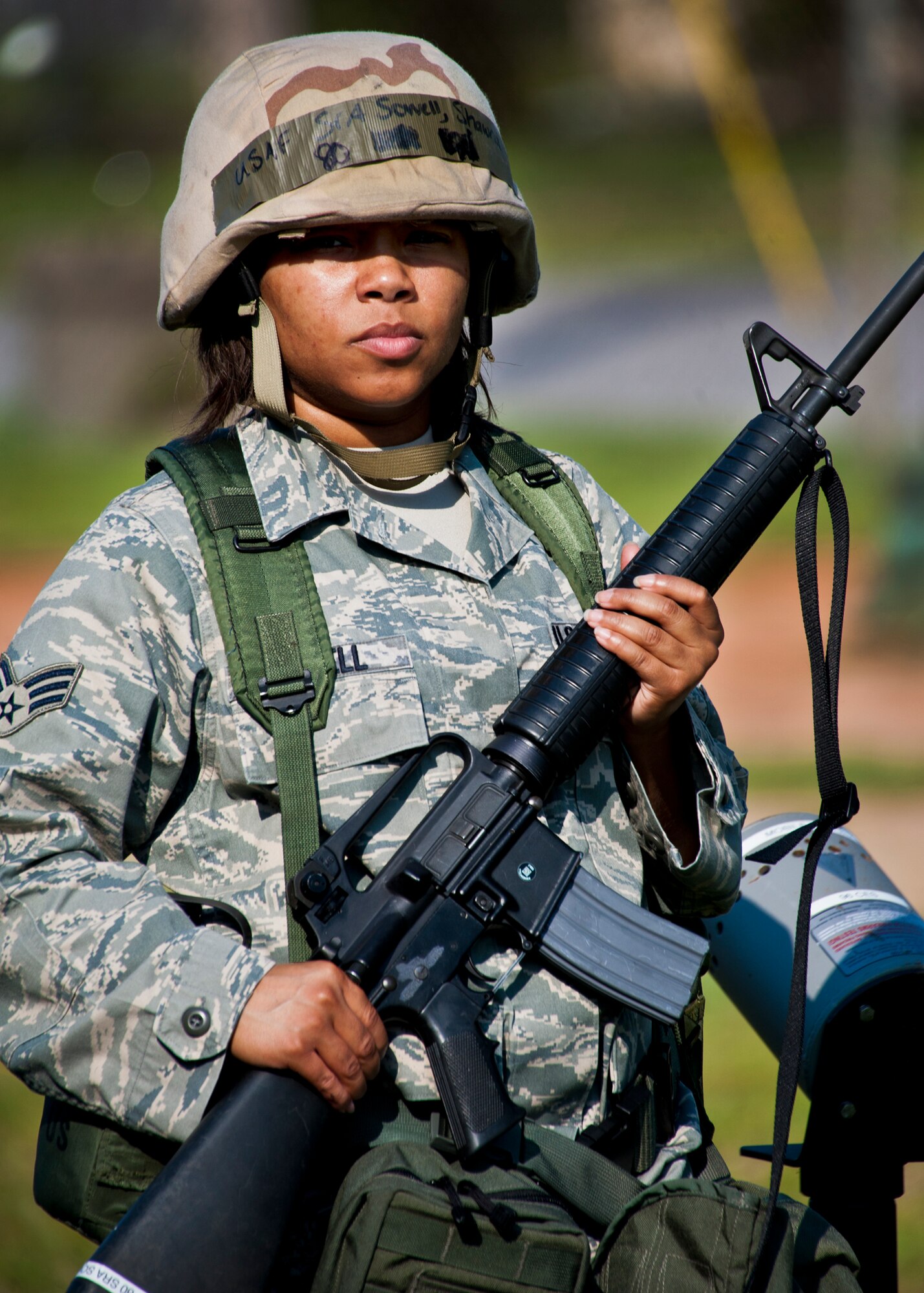 Senior Airman Shawna Sowell, of the 96th Medical Support Squadron, stands by her post guarding the tent during the Phase II exercise Aug. 12 at Eglin Air Force Base, Fla.  More than 100 Airmen braved black flag conditions (and rain) in chemical gear and gas masks to execute self-aid and buddy care, security and chemical attack avoidance missions.  The Phase II was part of a large week-long Operational Readiness Exercise on base.  (U.S. Air Force photo/Samuel King Jr.)