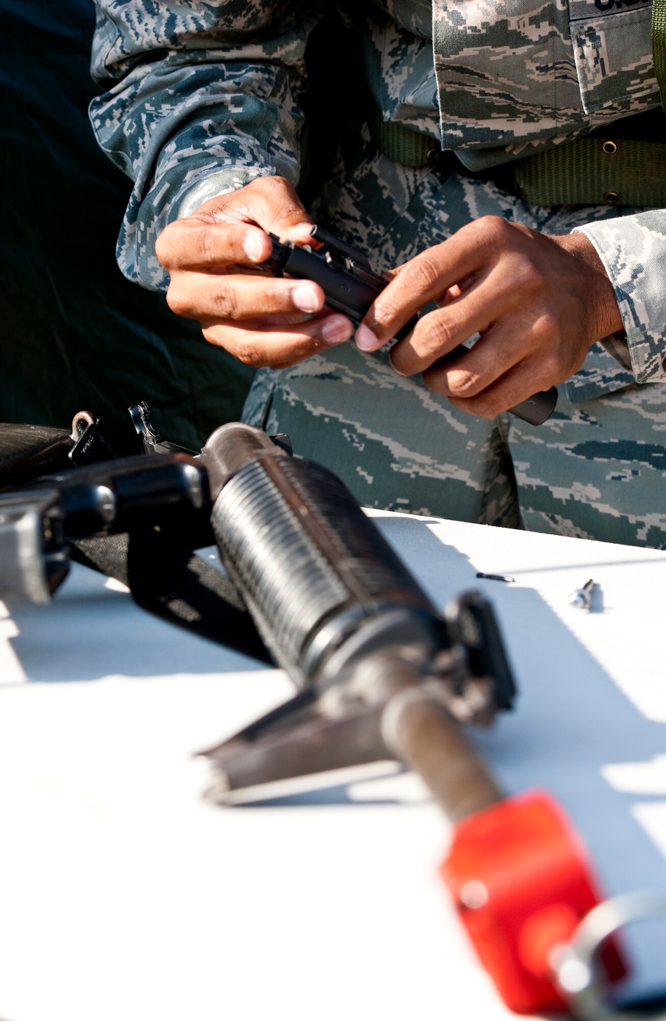 Staff Sgt. Cedric Brown, of the 96th Force Support Squadron, checks outside of the tent after a simulated attack during the Phase II exercise Aug. 10 at Eglin Air Force Base, Fla.  More than 100 Airmen braved black flag conditions (and rain) in chemical gear and gas masks to execute self-aid and buddy care, security and chemical attack avoidance missions.  The Phase II was part of a large week-long Operational Readiness Exercise on base.  (U.S. Air Force photo/Samuel King Jr.)