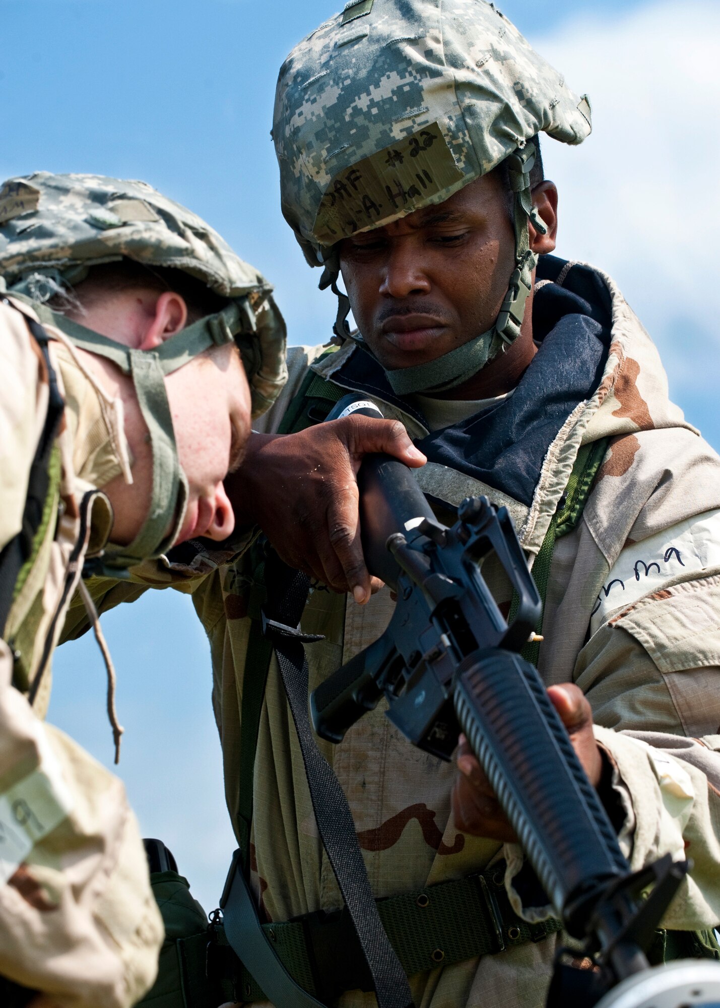 Tech. Sgt. Adrian Hall, of the 96th Aerospace Medicine Squadron, ensures there is no round in the chamber of his weapon before entering the tent during the Phase II exercise Aug. 10 at Eglin Air Force Base, Fla.  More than 100 Airmen braved black flag conditions (and rain) in chemical gear and gas masks to execute self-aid and buddy care, security and chemical attack avoidance missions.  The Phase II was part of a large week-long Operational Readiness Exercise on base.  (U.S. Air Force photo/Samuel King Jr.)