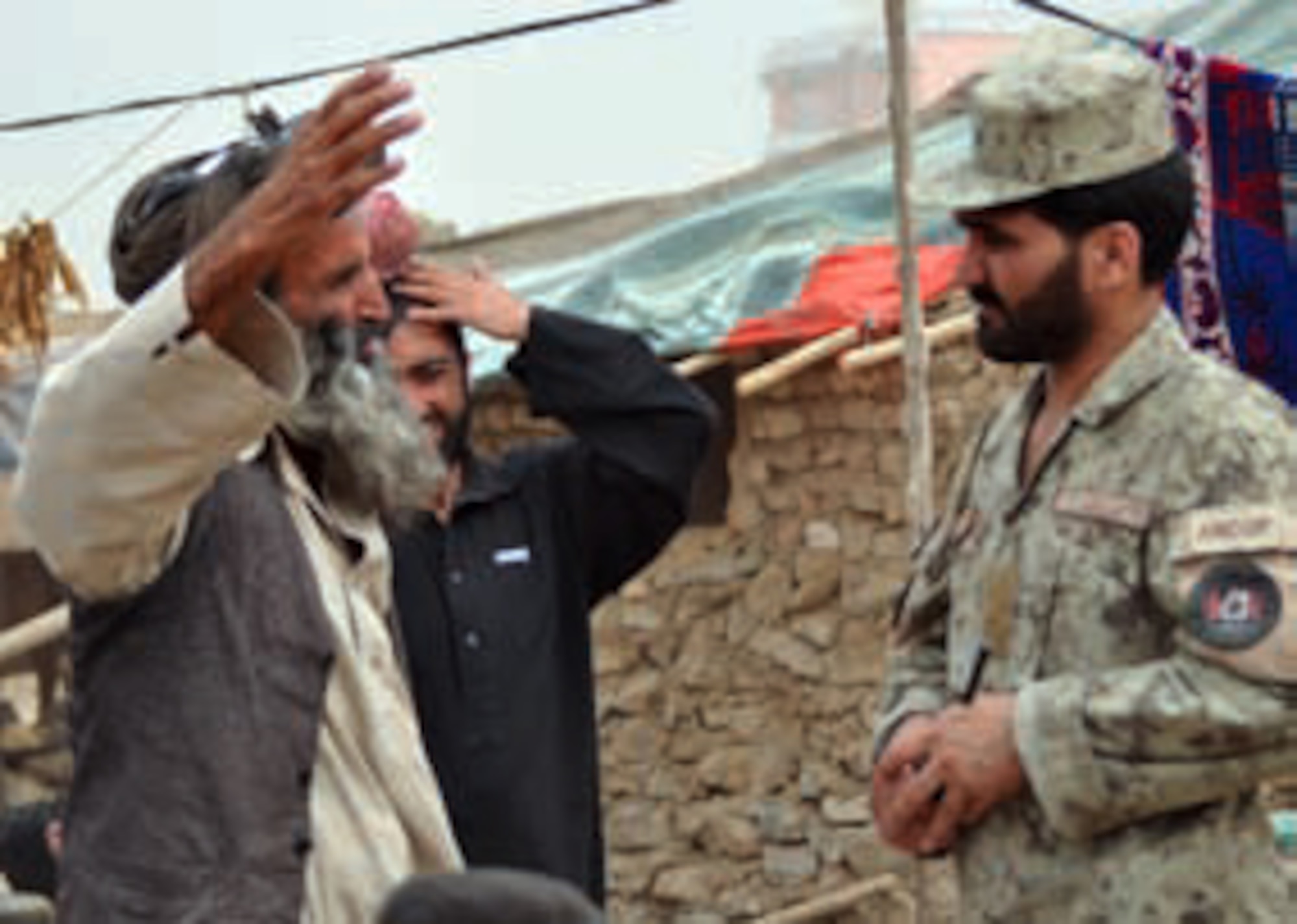 Scenes from an Afghan refugee camp show the poor living conditions residents face. Afghan police visit these camps in an effort to provide hope and assistance to these families, to help and protect these citizens as they try to survive in this war-torn land. (U.S. Air Force photo by Capt Ashley Norris)