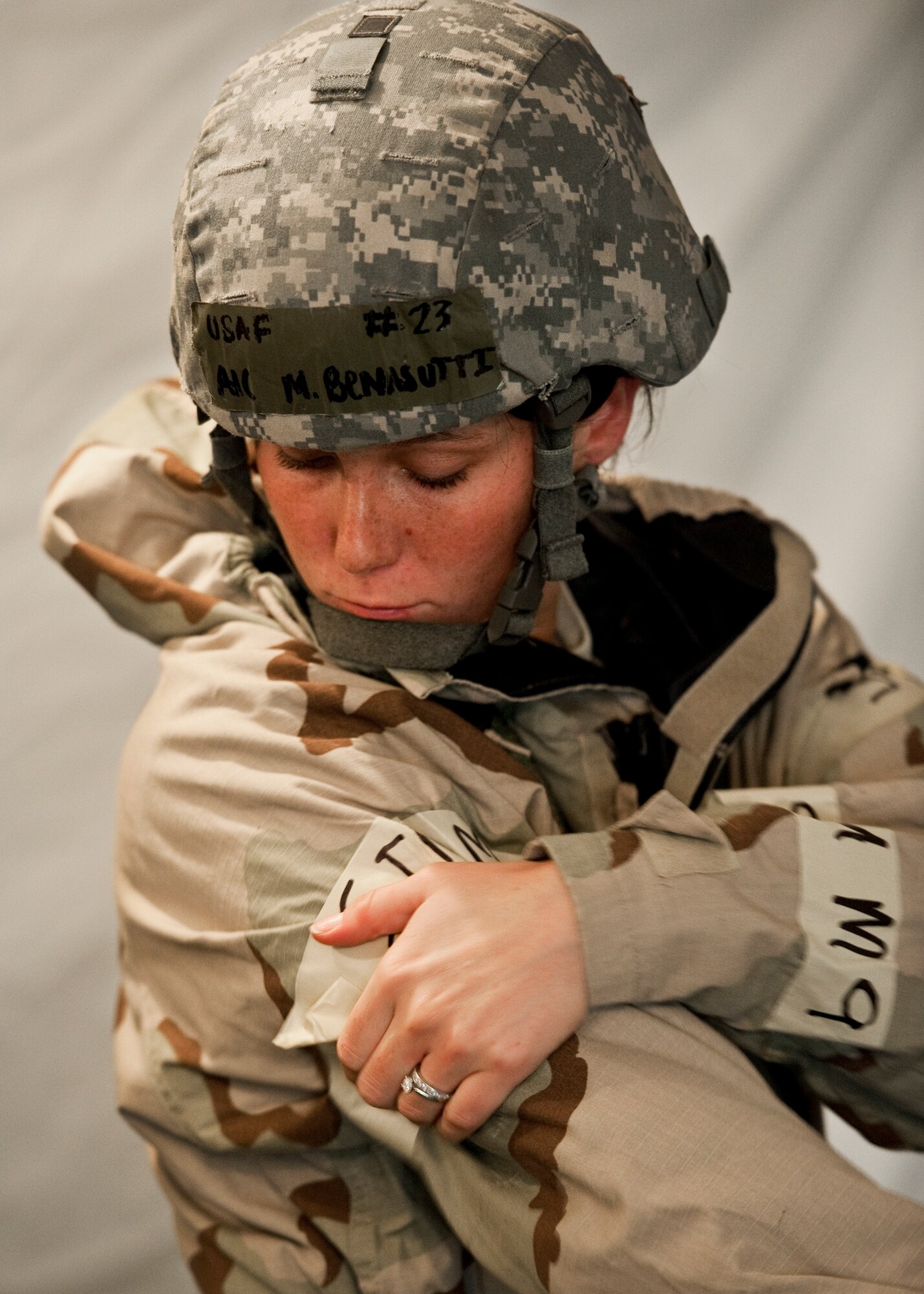 Airman 1st Class Marianna Benasutti, 96th Medical Operations Squadron, secures her M-9 tape to her J-list suit during an increased mission oriented protective posture level at the Phase II exercise Aug. 10 at Eglin Air Force Base, Fla. More than 100 Airmen braved black flag conditions in chemical gear and gas masks to execute self-aid and buddy care, security and chemical attack avoidance missions.  The Phase II was part of a large week-long Operational Readiness Exercise on base.  (U.S. Air Force photo/Samuel King Jr.)