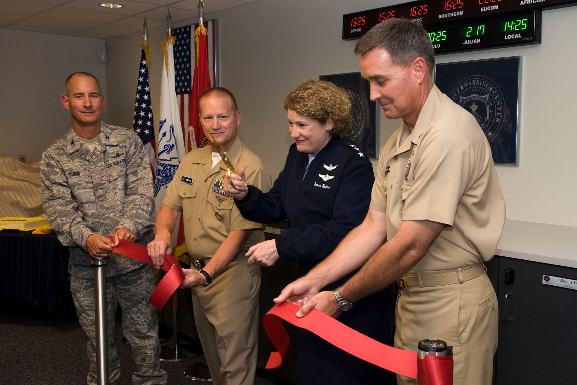 Lt. Gen. Susan Helms, 14th Air Force commander, (center) cuts a ribbon commemorating the completion of a $2.9 million renovation at the JFCC SPACE Missile Warning Center, Aug. 5, 2011, at Cheyenne Mountain Air Force Station. Navy Capt. David Kiehl, MWC director (right), Navy Senior Chief Phil Fix, MWC senior enlisted advisor (second from left), and Col. Joe Turk (left), 721st Mission Support Group commander, assist Helms during the ceremony. (U.S. Air Force photo/Craig Denton)