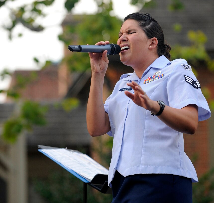 Senior Airman Amy Chicavich, Heritage Rambler vocalist, serenades the crowd during the Summer Breeze concert series Aug. 10, 2011, in Williamsburg, Va. The Heritage Ramblers were formed in 2010 with a mission to preserve and present the rich heritage of traditional jazz.  (U.S. Air Force photo by Staff Sgt. Dana Hill/Released)