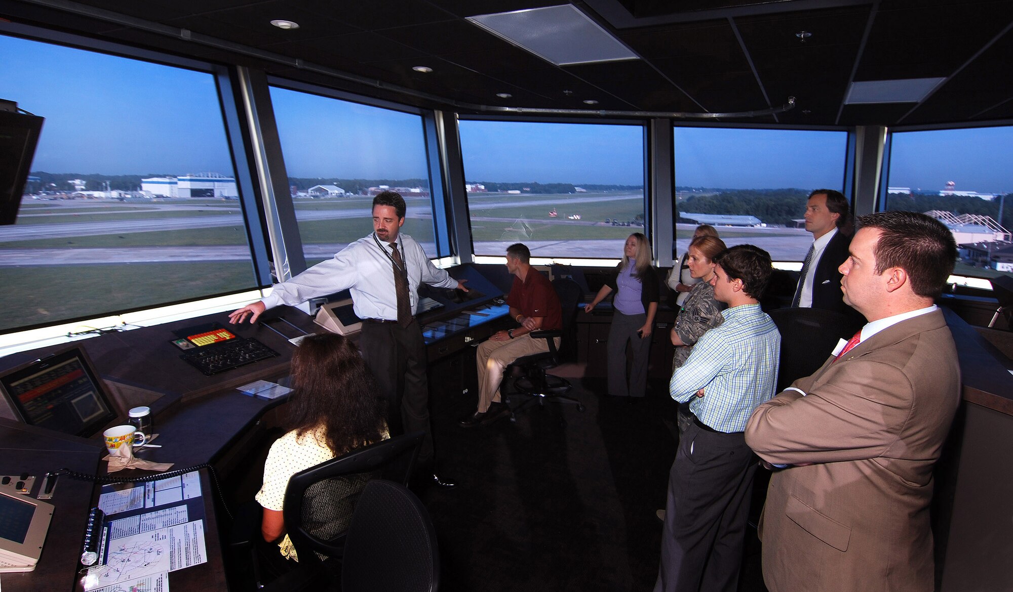 David Seal, 94th Operations Group Air Traffic Control Manager, tells Georgia congressional staff members what takes place at the three air traffic control consoles along the windows of the new Dobbins Air Reserve Base Control Tower, Aug 12. Staffers from various Georgia congressional offices visited Dobbins today for breakfast and a look at the new base control tower which was opened here just last week.  (U.S. Air Force photo/ Brad Fallin)