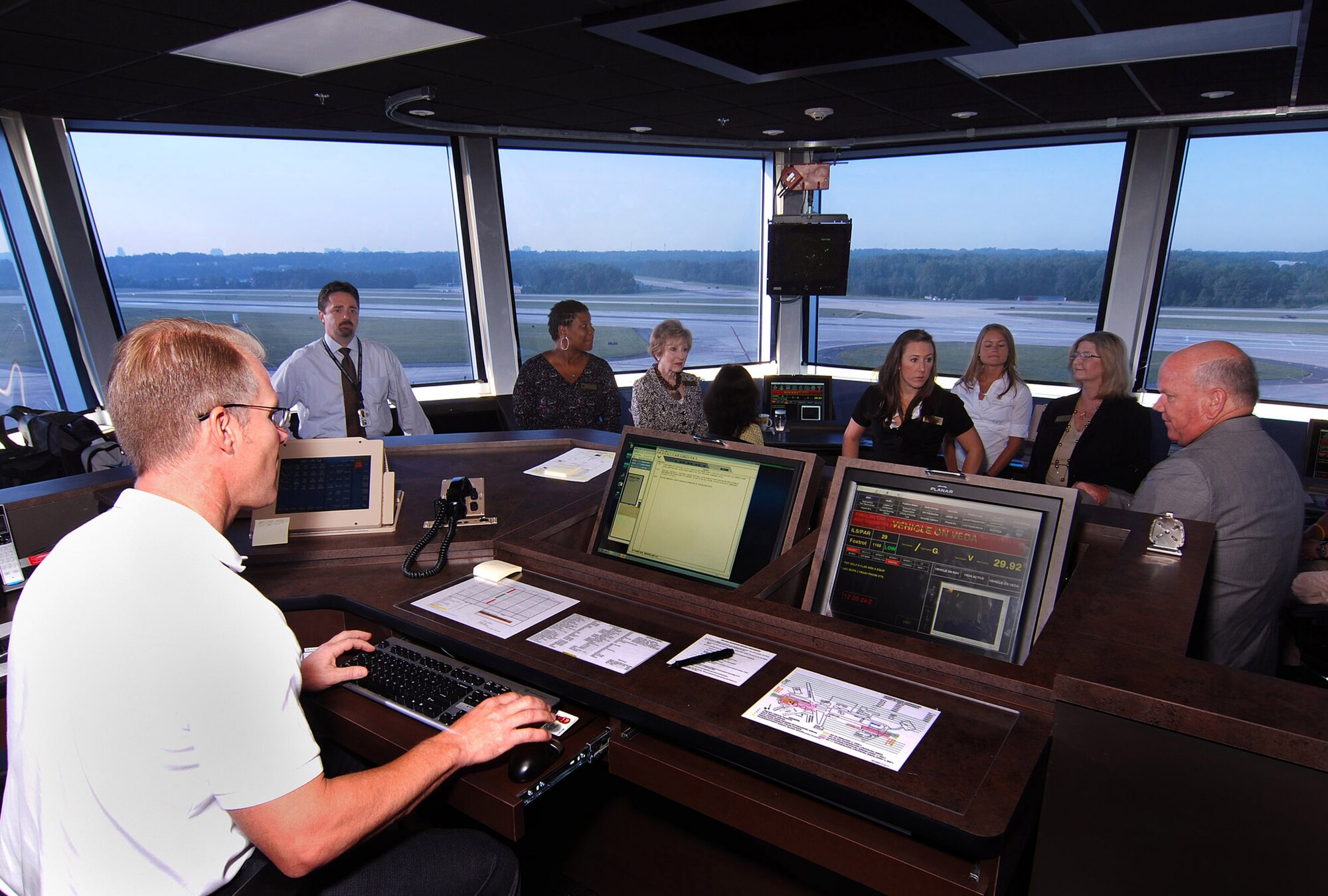 Hank VonRuden, 94th Operations Group Air Traffic Watch Supervisor, tells Georgia congressional staff members what he does at the center console in the new Dobbins Air Reserve Base Control Tower, Aug 12. Staffers from various Georgia congressional offices visited Dobbins today for breakfast and a look at the new base control tower which was opened here just last week.  (U.S. Air Force photo/ Brad Fallin)