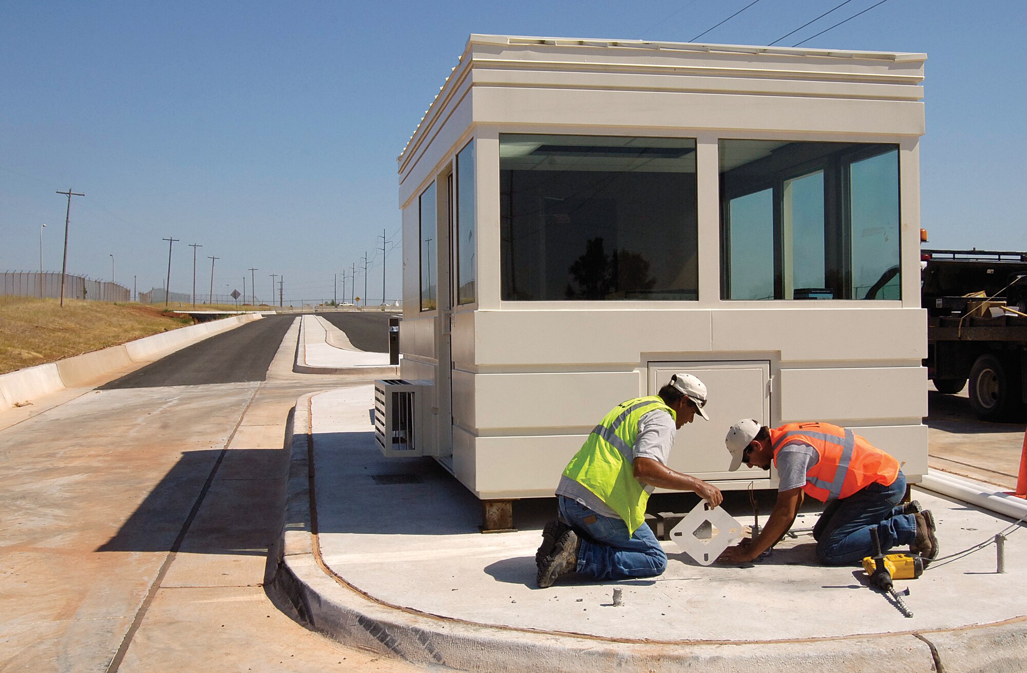 Contractors prepare the guard shack area for light fixtures Aug. 9 as construction continues on the Midwest Boulevard Gate east of Bldg. 9001.  (Air Force photo by Margo Wright)