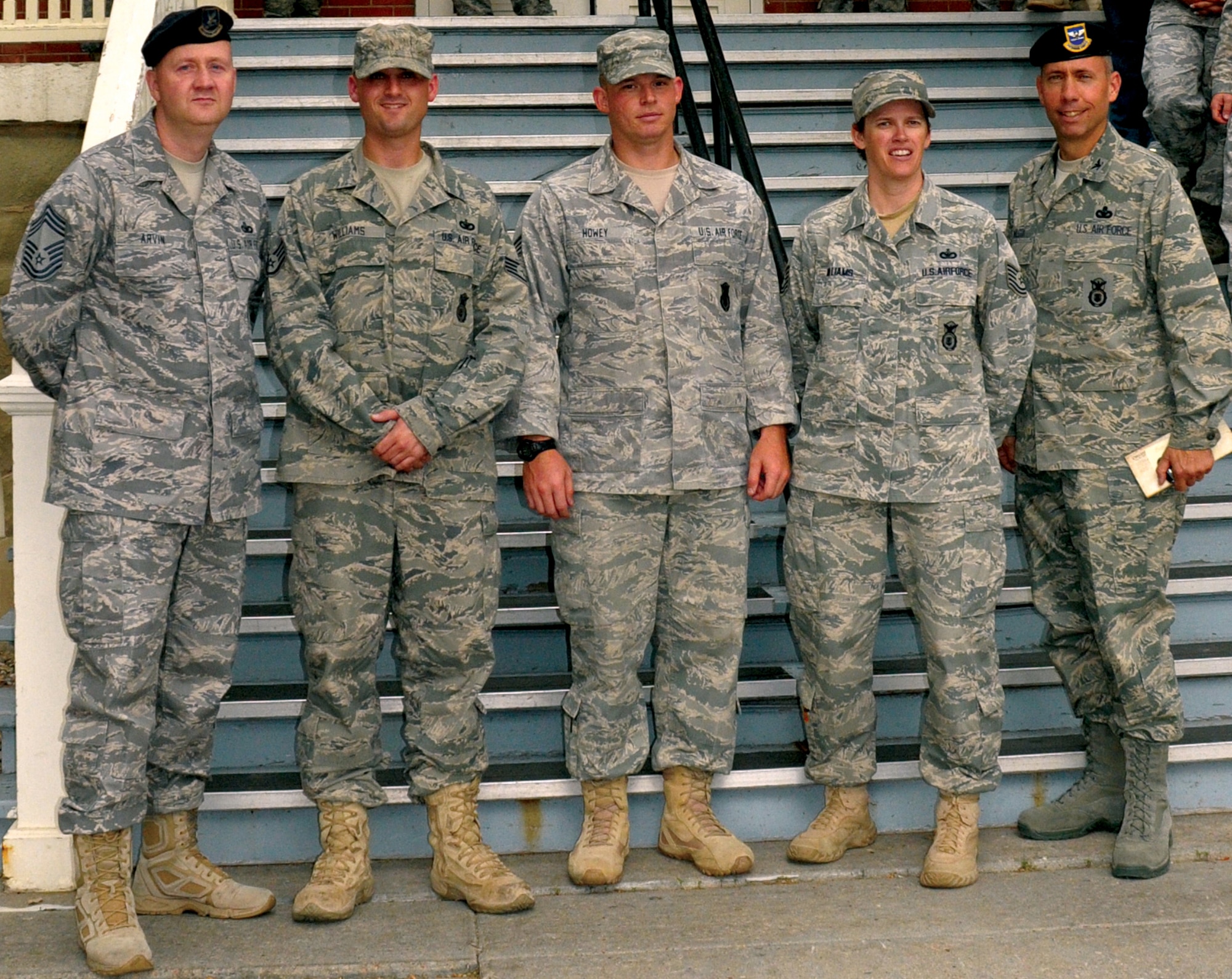 Chief Master Sgt. Dan Arvin, 90th Security Forces Group chief enlisted manager; Staff Sgt. Joshua Williams; Staff Sgt. Clifford Howey; Tech. Sgt. Penni Williams, all with the 90th SFG; and Col. Tom Wilcox, 90th SFG commander; pose for a photo in front of the 90th SFG headquarters Aug. 3. Sergeants Williams, Howey and Williams along with (not pictured) Staff Sgt. Jacob Fortier, Senior Airman Richard Huerta, Senior Airman James Himes, Senior Airman Carolyn Williams, Airman 1st Class, Timothy Mason, Airman 1st Class Fransiscus Thomas, Airman 1st Class Dela Wood, Airman 1st Class Lance Bollenberg, Airman 1st Class Brian Gill and Airman Michael Fitzgerald, all with the 90th SFG, comprised a 13-person team returning from a six-month deployment to Southeast Asia. (U.S. Air Force photo by Blaze Lipowski)