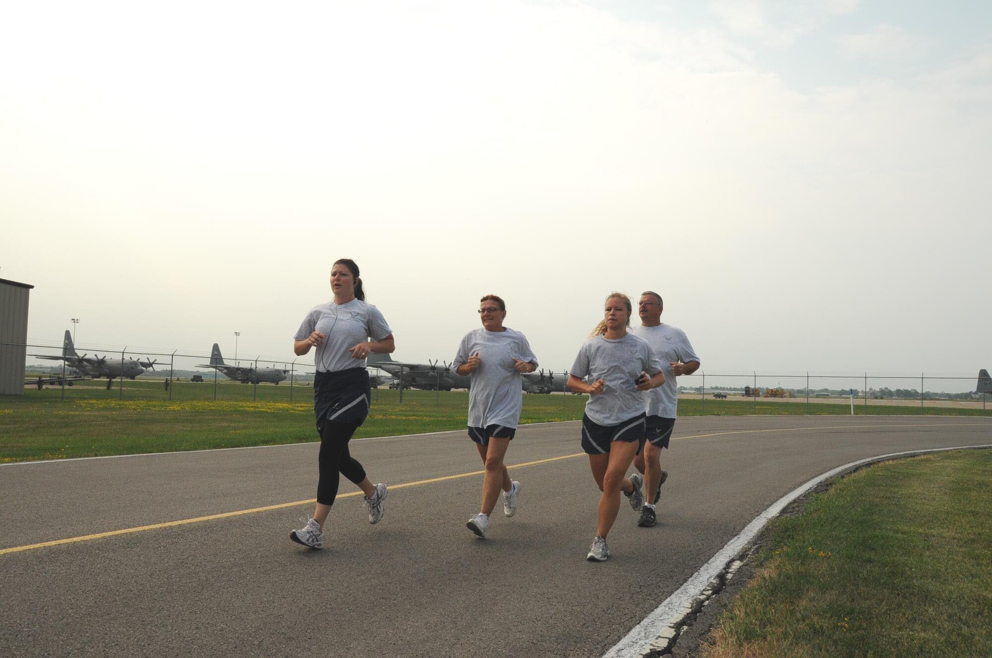 MSgt Melissa Shenefiel, MSgt Laura Thomas, TSgt Rachel Baker and MSgt Michael Margarucci doing their final phase of the PT test the 1 1/2 mile run.(Air Force Photo/SMSgt Ray Lloyd)