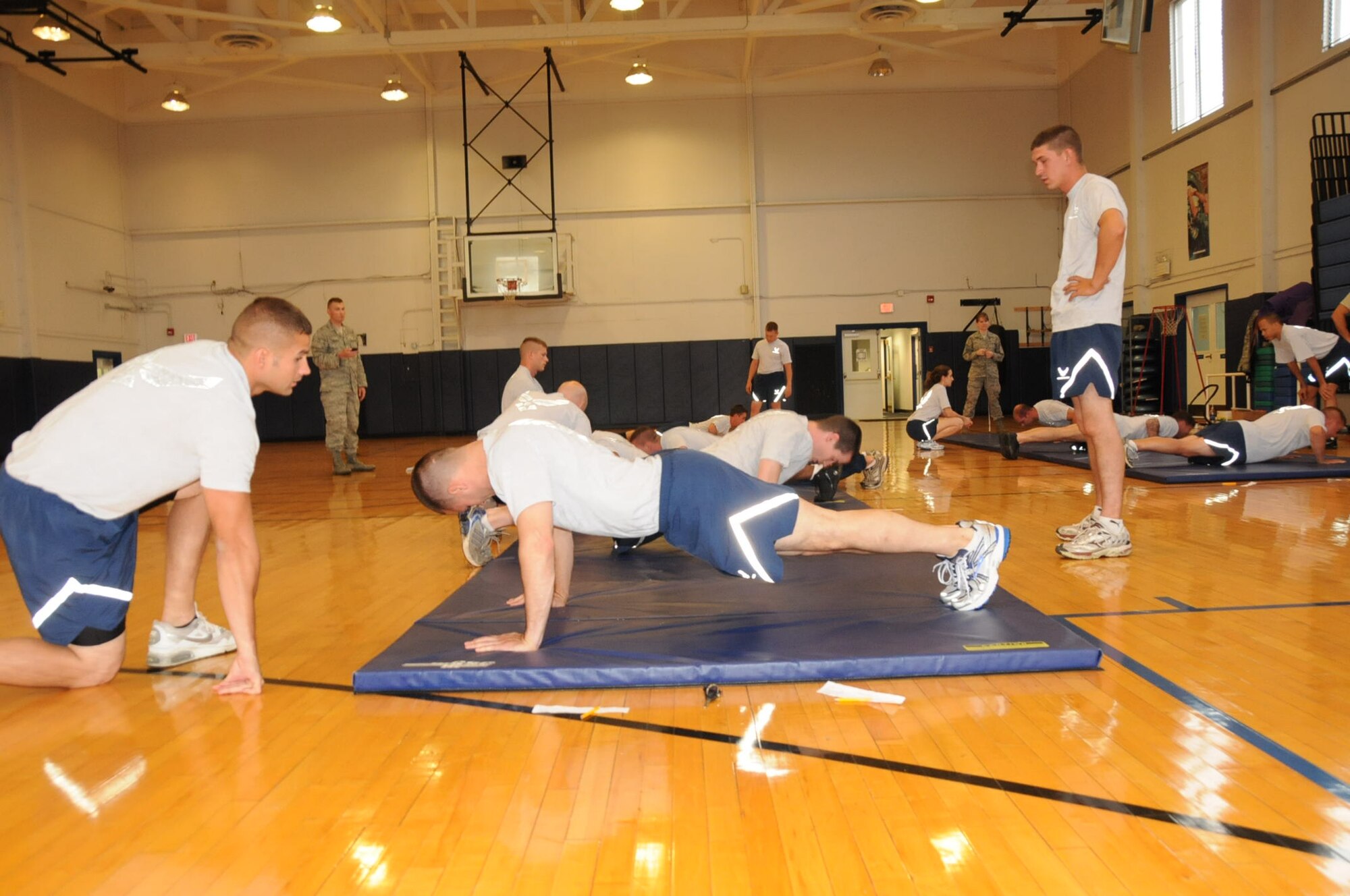 107th members conduct their physical training test at the base fitness center during the UTA weekend. Fitness monitors count pushups and make corrections as needed. (Air Force Photo/SMSgt Ray Lloyd)