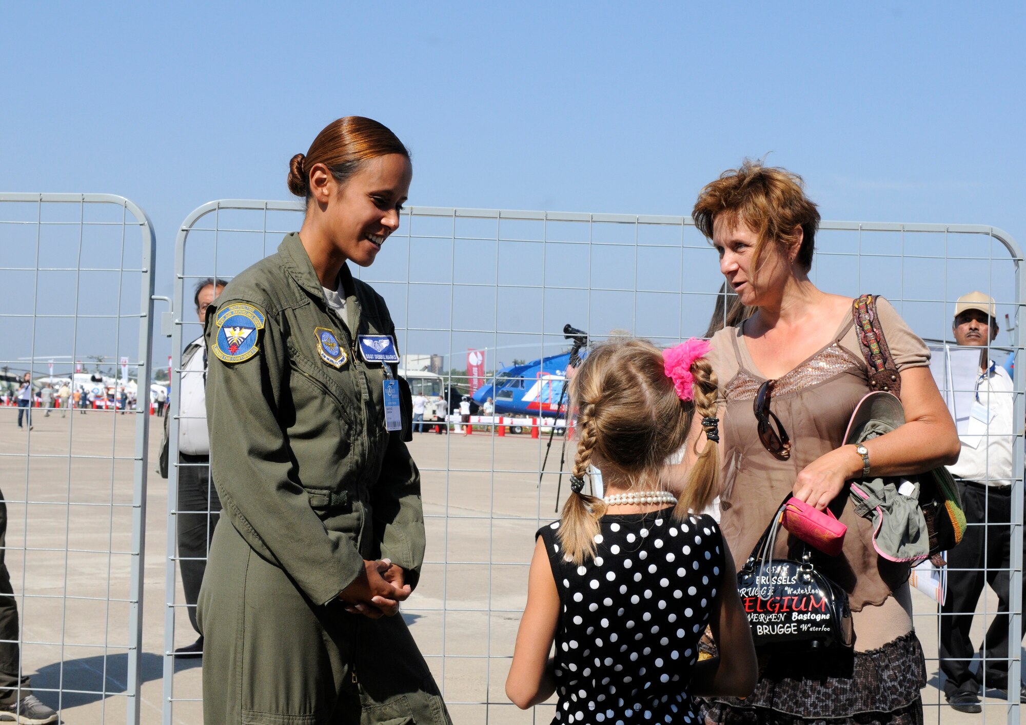 ZHUKOVSKY AIR FIELD, Russia – Staff Sgt. Debbie Marks, 32nd Air Refueling Squadron boom operator, talks to a mother and daughter after her daughter received a tour of the KC-10Extendor here Aug. 16 at the Moscow International Aviation and Space Salon. MAKS is one of the premier events of its type in the world, and Department of Defense participation demonstrates the United States commitment to international security, promotes international cooperation, and contributes to U.S. foreign policy objectives. The U.S. Air Force has a KC-10 Extender, two F-16C Fighting Falcons, two A-10 Thunderbolt II, one F-15E Strike Eagle, one B-52 Stratotanker, C-130J Super Hercules and C-5M Galaxy statics for the show.  (U.S. Air Force photo/Master Sgt. Kelley J. Stewart)