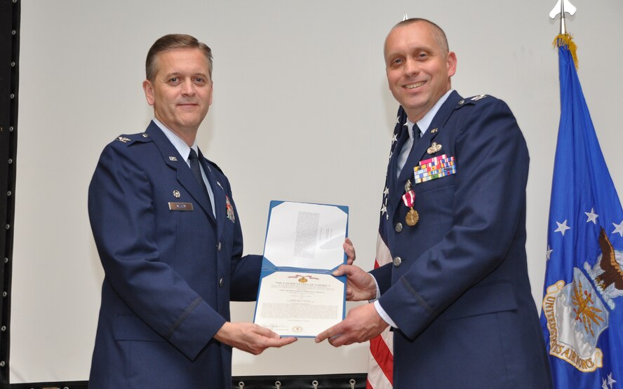 JOINT BASE ANDREWS, Md. -- Col. Russell A. Muncy (left), 459th Air Refueling Wing commander, presents a Meritorious Service Medal to Col. James A. Gray in a 459th Mission Support Group change of command ceremony here Aug. 13, 2011. Lt. Col. Dale Bateman assumed command of the 459th MSG from Colonel Gray who will be taking an Individual Mobilization Augmentee position at the Pentagon with the Air Force Reserve. (U.S. Air Force photo/Tech. Sgt. Steve Lewis)