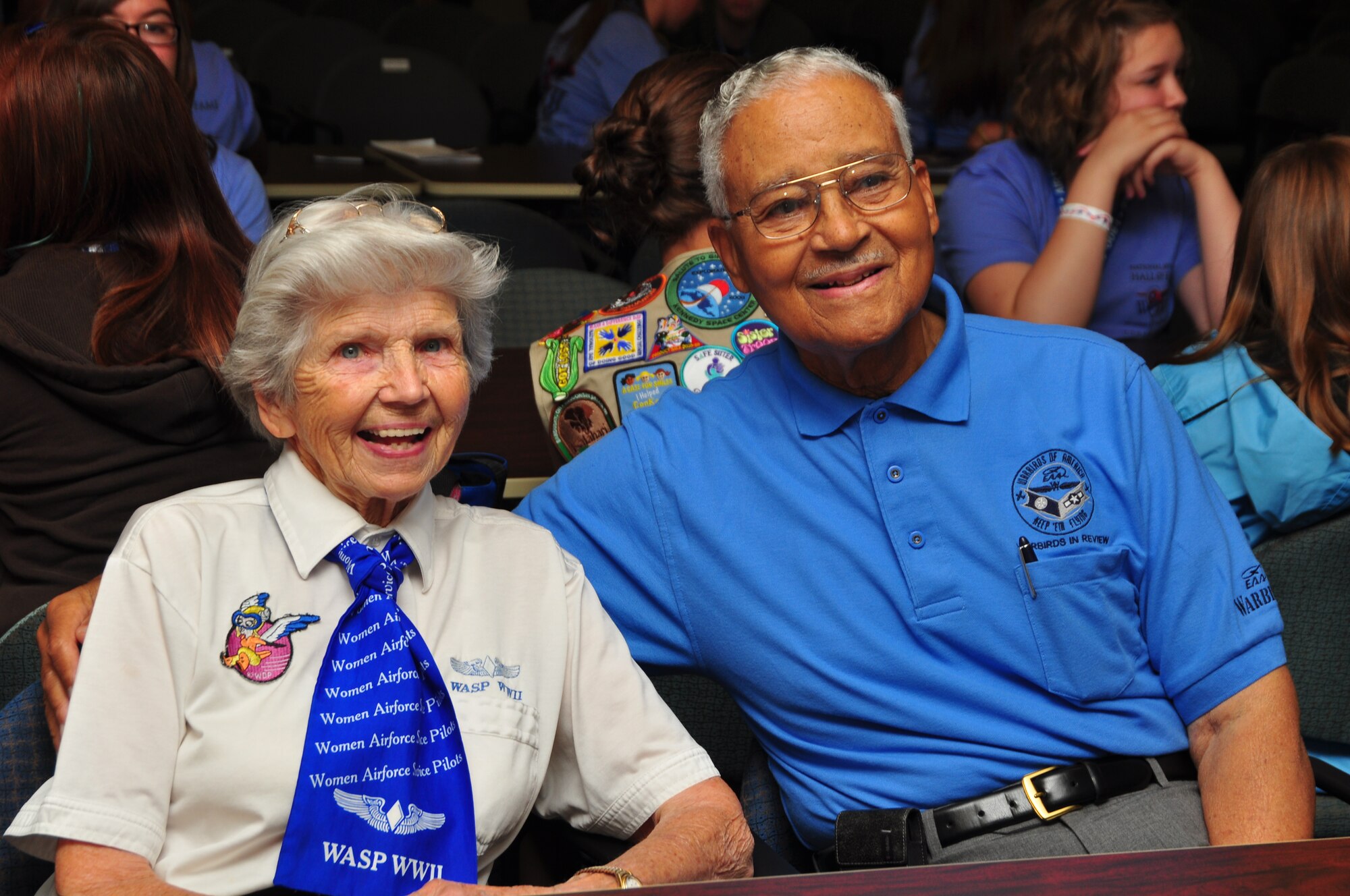 WRIGHT-PATTERSON AIR FORCE BASE, Ohio - Marty Wyall, Women Airforce Service Pilot, shares a moment with retired Col. Charles McGee, Tuskegee Airman, during the Women of Wings Conference July 15. Five WASP and three Tuskegee Airmen joined more than 50 teenagers for the two-day event that included a WASP and Tuskegee Airmen panel and a tour of the C-17 Globemaster III. (U.S. Air Force photo/Senior Airman Mikhail Berlin)