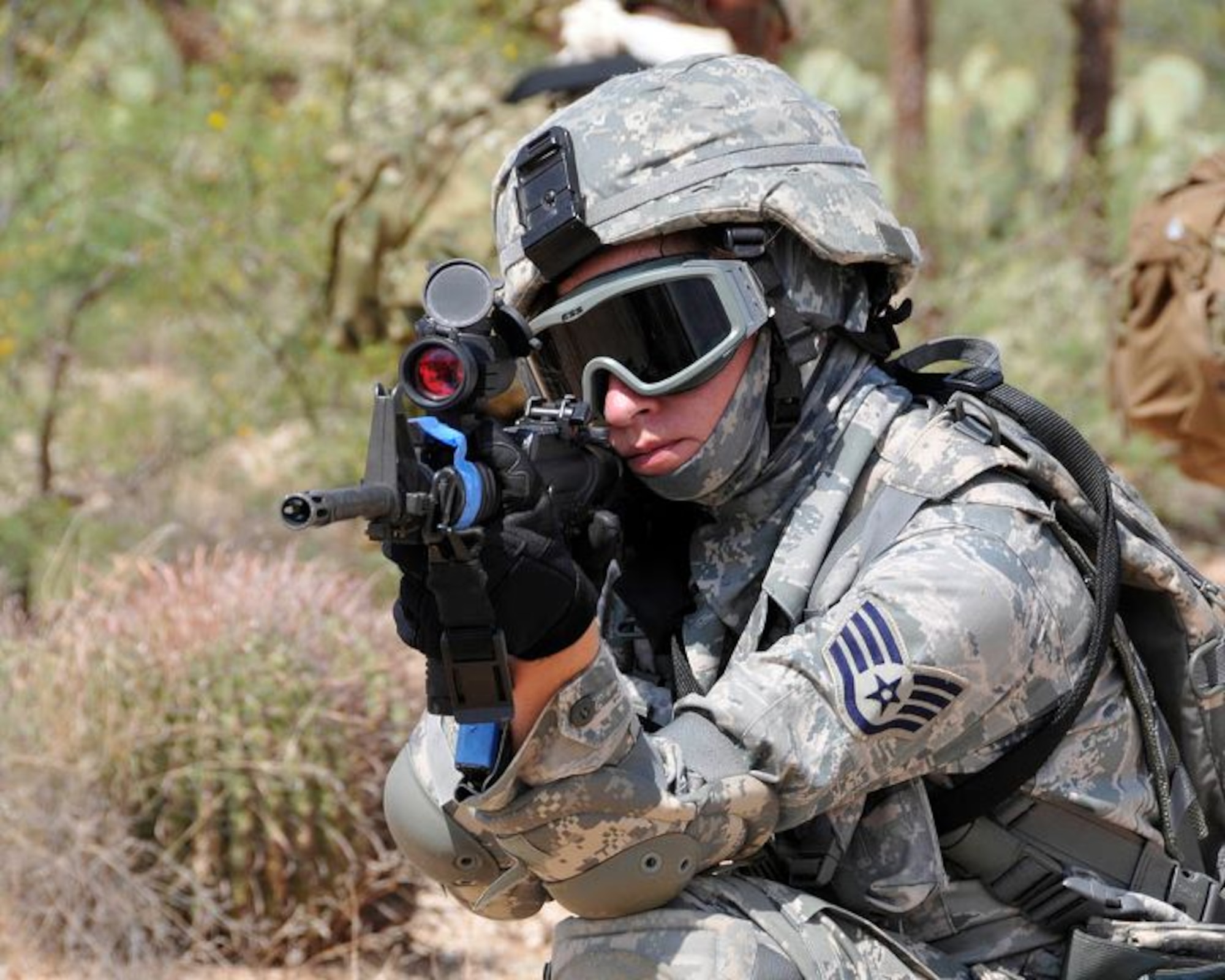 Staff Sgt. Haley Bia, security forces, aims her M-4 rifle durng a rescue exercise August 10 at Davis-Monthan Air Force Base, Ariz. (U.S. Air Force photo/Master Sgt. Dave Neve)