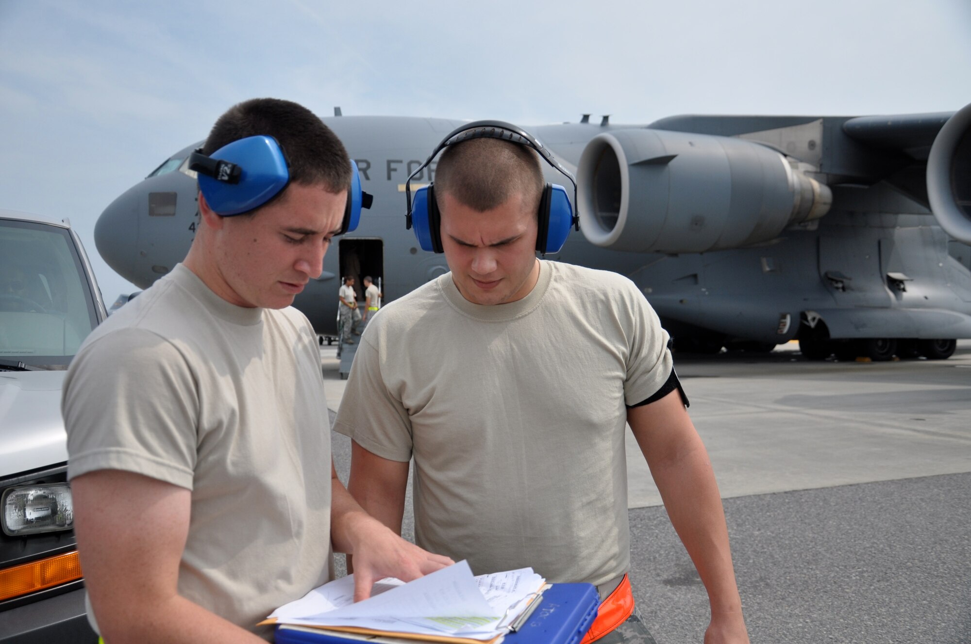 WRIGHT-PATTERSON AIR FORCE BASE, Ohio - Senior Airmen Marcus Loel and Michael Osborne, 87th Aerial Port Squadron, check the cargo manifest for a C-17 Globemaster III while on annual tour at Joint Base Charleston, S.C., July 12. (U.S. Air Force photo/Tech. Sgt. Jeremy Caskey)