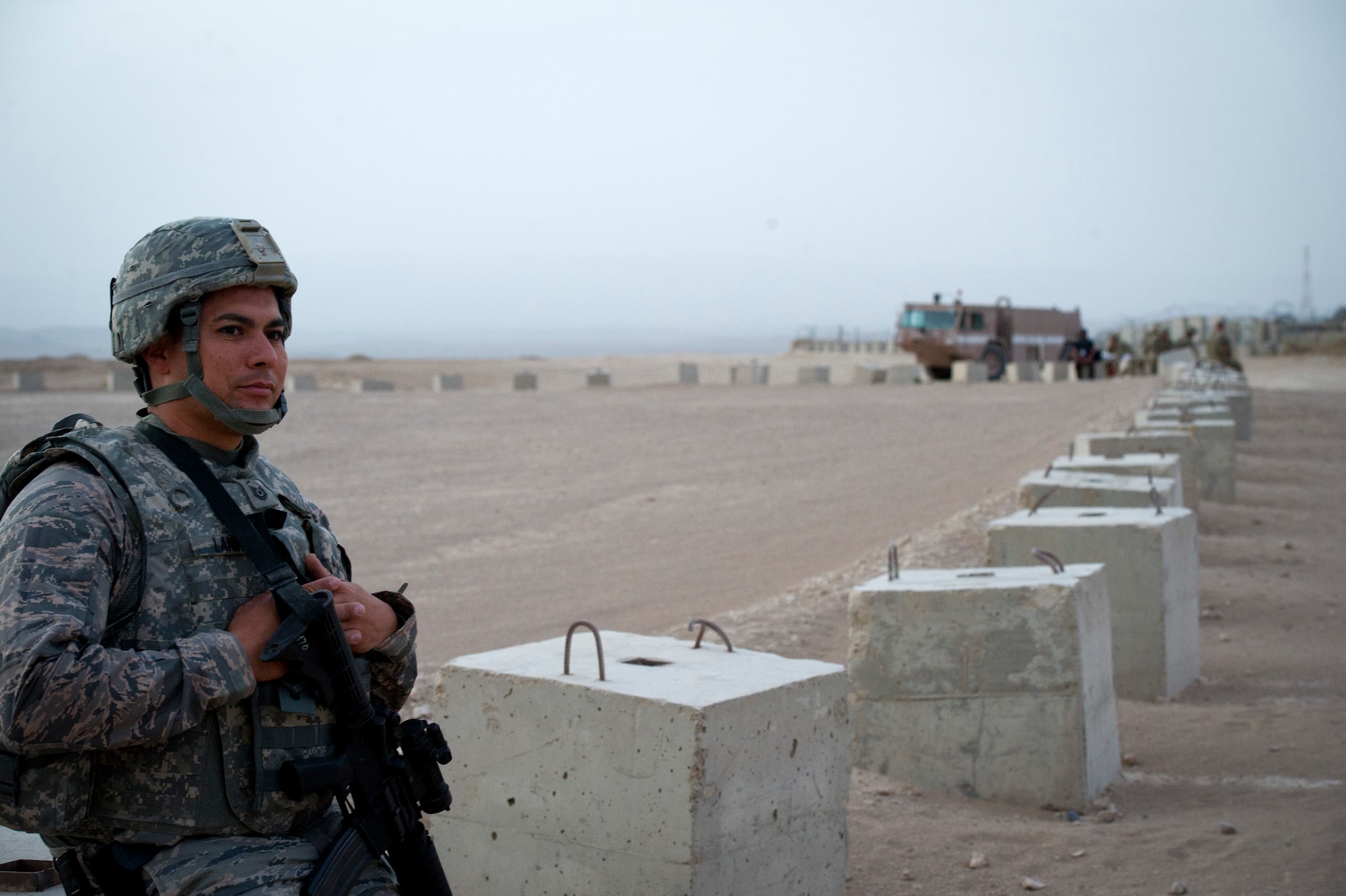 U.S. Air Force Master Sgt. Robert Laning, fire chief, waits for a C-130 to land outside of Forward Operating Base Apache, Afghanistan, Aug. 14, 2011. The C-130 brought personnel into the base and delivered the firefighters fx kit, which contains additional supplies. The firefighters are part of a team, deployed to set up crash, fire and rescue at a bare base. (U.S. Air Force photo by Staff Sgt. David Salanitri)
