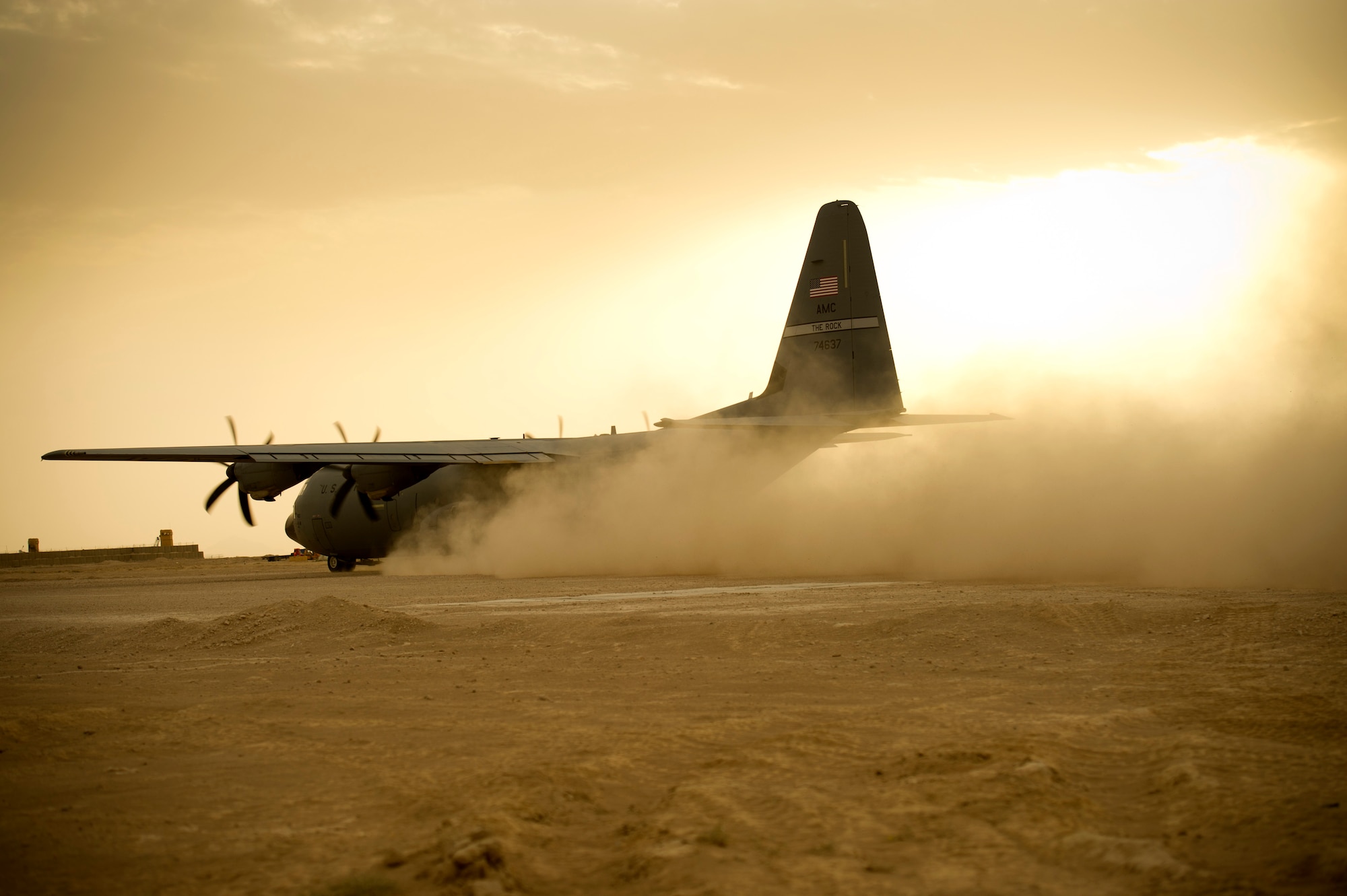 A C-130 takes off on a dirt landing strip in Qalat, Afghanistan Aug. 14, 2011.  The C-130 transported Army passengers and cargo. (U.S. Air Force photo by Staff Sgt. David Salanitri)