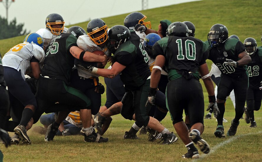 MISAWA AIR BASE, Japan -- Yakota Air Base Warriors try to advance the ball, with little success, Aug 13.  Misawa played host to United States Forces Japan-American Football League North division championship game, where the Misawa Jets defeated the Yokota Warriors by a score of 21-14.  The Jets have earned a berth in the USFJ-AFL Torii Bowl.  (U.S. Air Force photo by Master Sgt. Maria J. Bare)