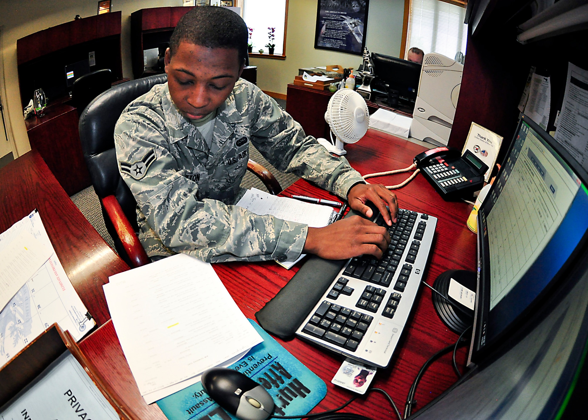 Airman 1st Class Mark Patton, 51st Fighter Wing staff, in-processes some paperwork through the 51st FW/CCEA office Aug. 10, 2011. Patton was recently recognized for his hard work and dedication to his job through the Airman Spotlight program. (U.S. Air Force photo/Tech. Sgt. Chad Thompson)