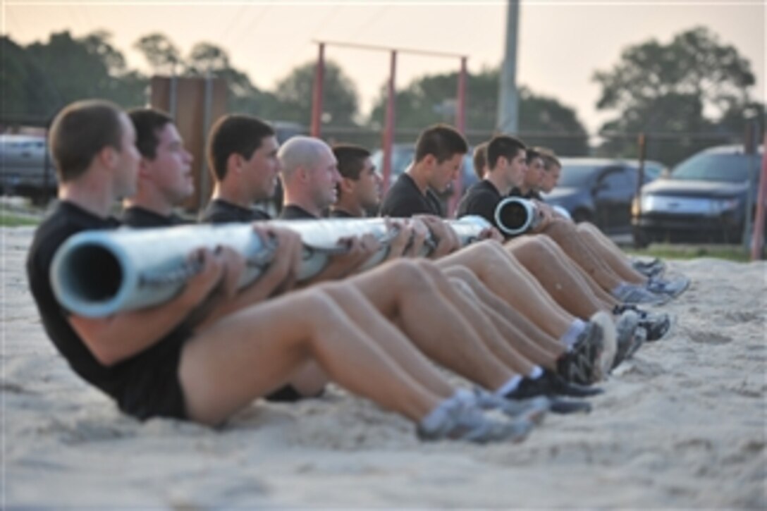 U.S. Air Force Tactical Air Control Party candidates from Falcon Flight 87 perform team sit-ups during a physical training session at Hurlburt Field, Fla., on Aug. 10, 2011.  